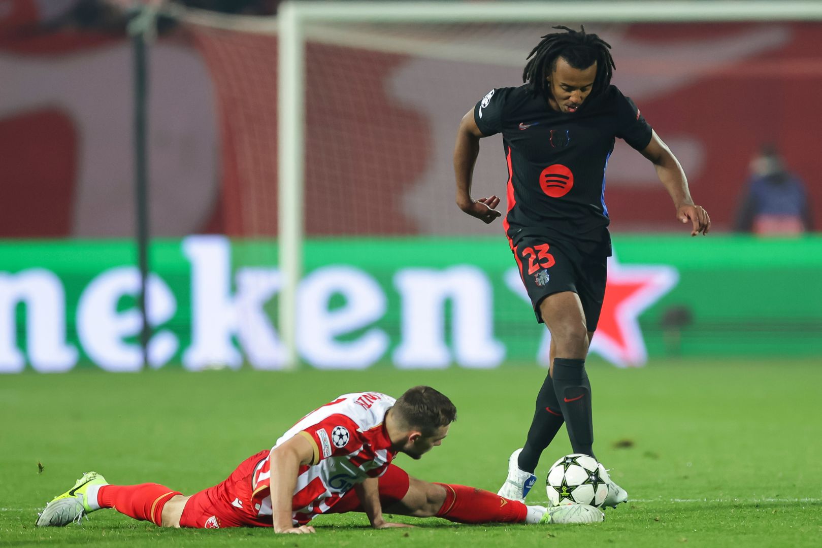 BELGRADE, SERBIA - NOVEMBER 6: Jules Kounde (R) of Barcelona in action against Timi Elsnik (L) of Crvena Zvezda during the UEFA Champions League 2024/25 League Phase MD4 match between FK Crvena Zvezda and FC Barcelona at Stadium Rajko Mitic on November 6, 2024 in Belgrade, Serbia.