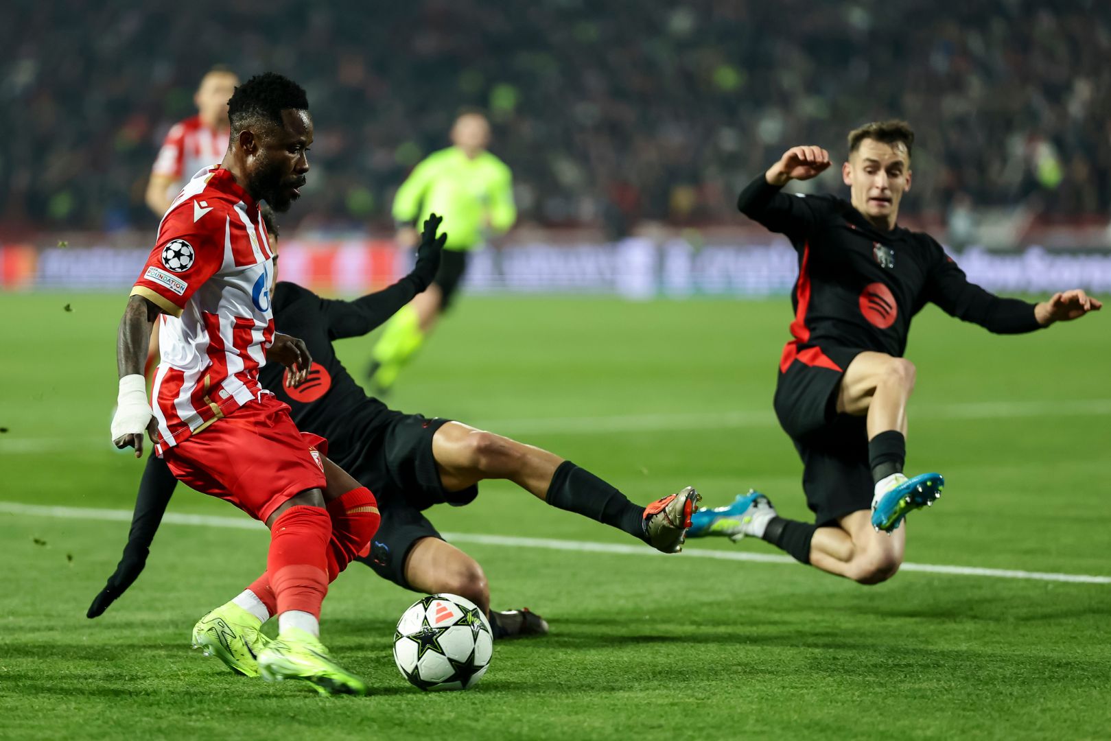 BELGRADE, SERBIA - NOVEMBER 6: Guelor Kanga (L) of Crvena Zvezda in action against Marc Casado (R) and Frenkie de Jong (R) of Barcelona during the UEFA Champions League 2024/25 League Phase MD4 match between FK Crvena Zvezda and FC Barcelona at Stadium Rajko Mitic on November 6, 2024 in Belgrade, Serbia.