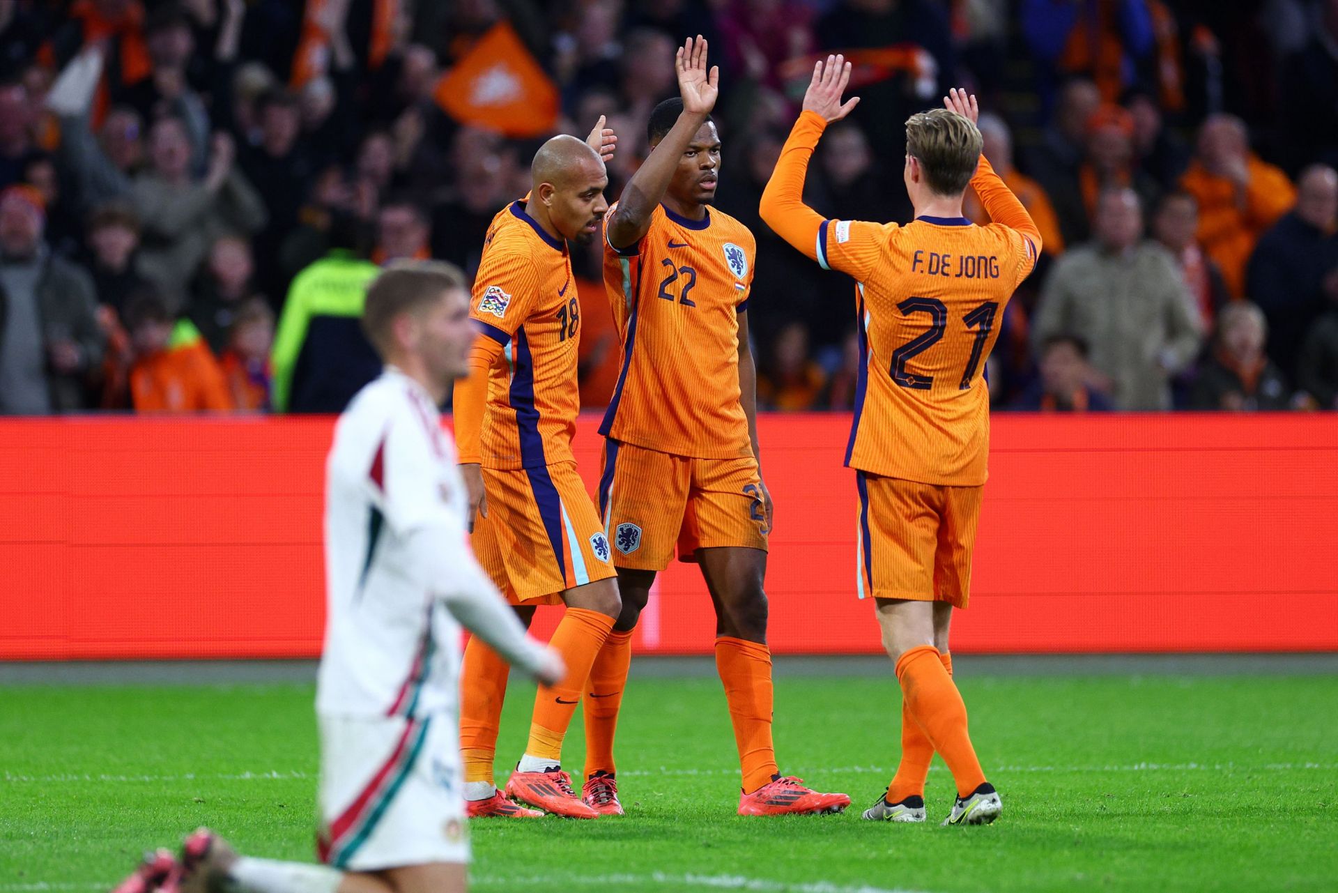 AMSTERDAM, NETHERLANDS - NOVEMBER 16: Denzel Dumfries of Netherlands celebrates scoring his team's third goal with team mates Donyell Malen and Frenkie de Jong of Netherlands during the UEFA Nations League 2024/25 League A Group A3 match between Netherlands and Hungary at the Johan Cruijff Arena on November 16, 2024 in Amsterdam, Netherlands.