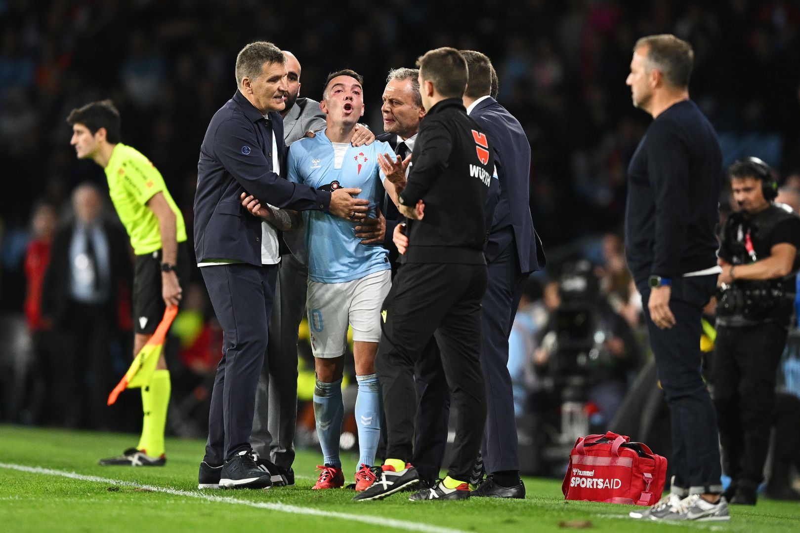 VIGO, SPAIN - NOVEMBER 23: Iago Aspas of Celta Vigo is held back by coaching staff as he clashes with an assistant referee during the LaLiga match between RC Celta de Vigo and FC Barcelona at Estadio Balaidos on November 23, 2024 in Vigo, Spain.
