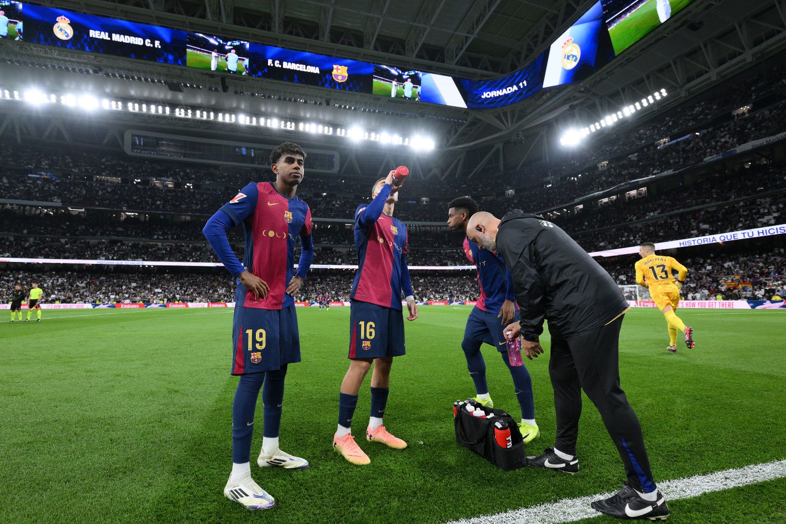 Lamine Yamal and Fermin Lopez of FC Barcelona react prior to the LaLiga match between Real Madrid CF and FC Barcelona at Estadio Santiago Bernabeu on October 26, 2024 in Madrid, Spain.