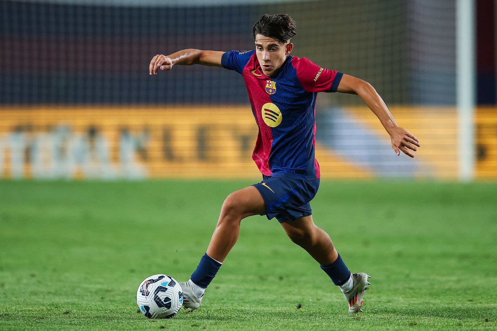 BARCELONA, SPAIN - AUGUST 12: Toni Fernandez of FC Barcelona run with the ball during the Joan Gamper Trophy match between FC Barcelona and AS Monaco at Estadi Olimpic Lluis Companys on August 12, 2024 in Barcelona, Spain.