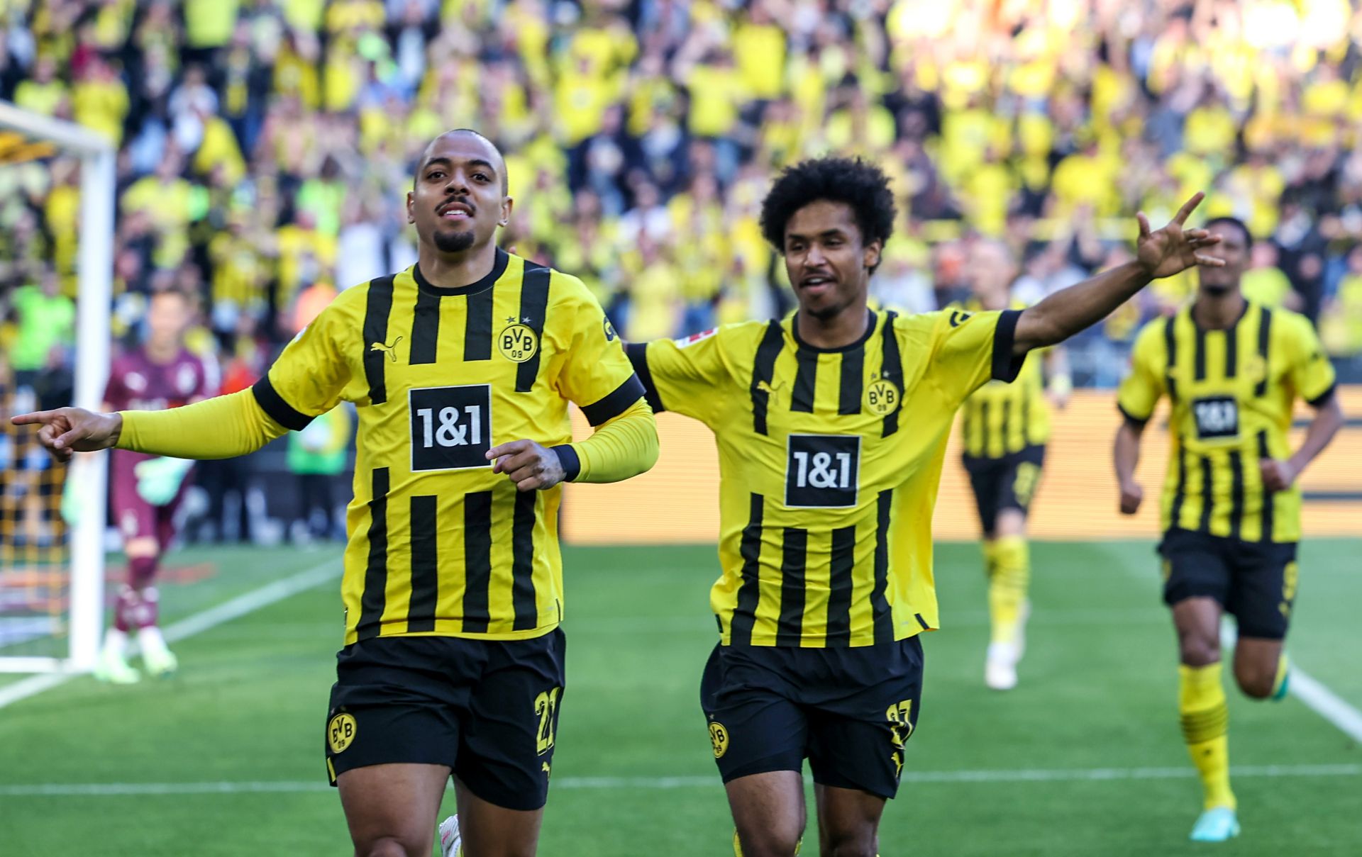 DORTMUND, GERMANY - MAY 13: Donyell Malen of Borussia Dortmund celebrates with teammate Karim Adeyemi after scoring the team's first goal during the Bundesliga match between Borussia Dortmund and Borussia Mönchengladbach at Signal Iduna Park on May 13, 2023 in Dortmund, Germany.