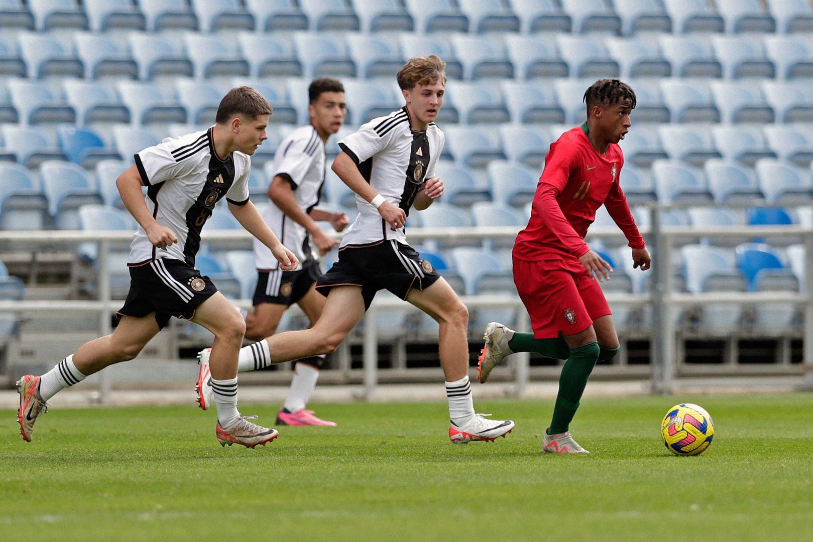 ALMANCIL, PORTUGAL - FEBRUARY 14: Nick Cherny (L) and Kacper Koscierski (C) of U17 Germany challenges Cardoso Varela (R) of U17 Portugal during the Portugal U17 v Germany U17 - Algarve Cup match on February 14, 2024 in Almancil, Portugal.