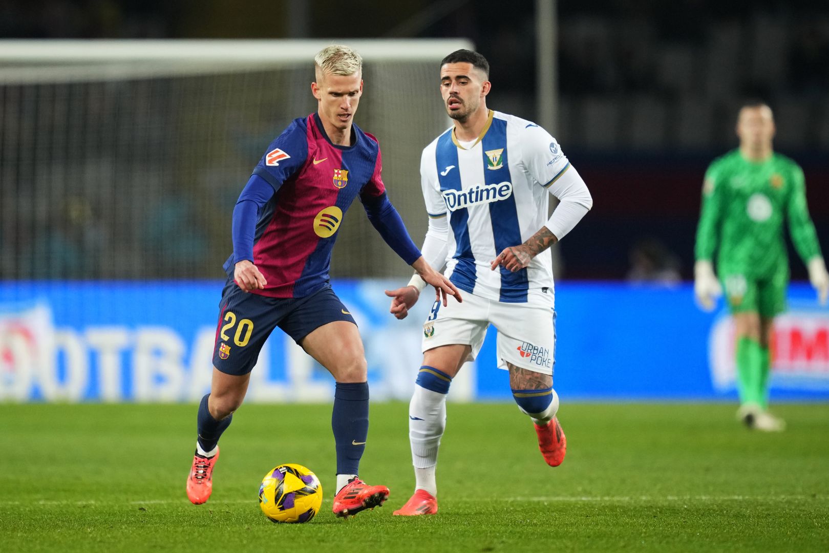 BARCELONA, SPAIN - DECEMBER 15: Dani Olmo of FC Barcelona runs with the ball whilst under pressure from Miguel De La Fuente of CD Leganes during the LaLiga match between FC Barcelona and CD Leganes at Estadi Olimpic Lluis Companys on December 15, 2024 in Barcelona, Spain.