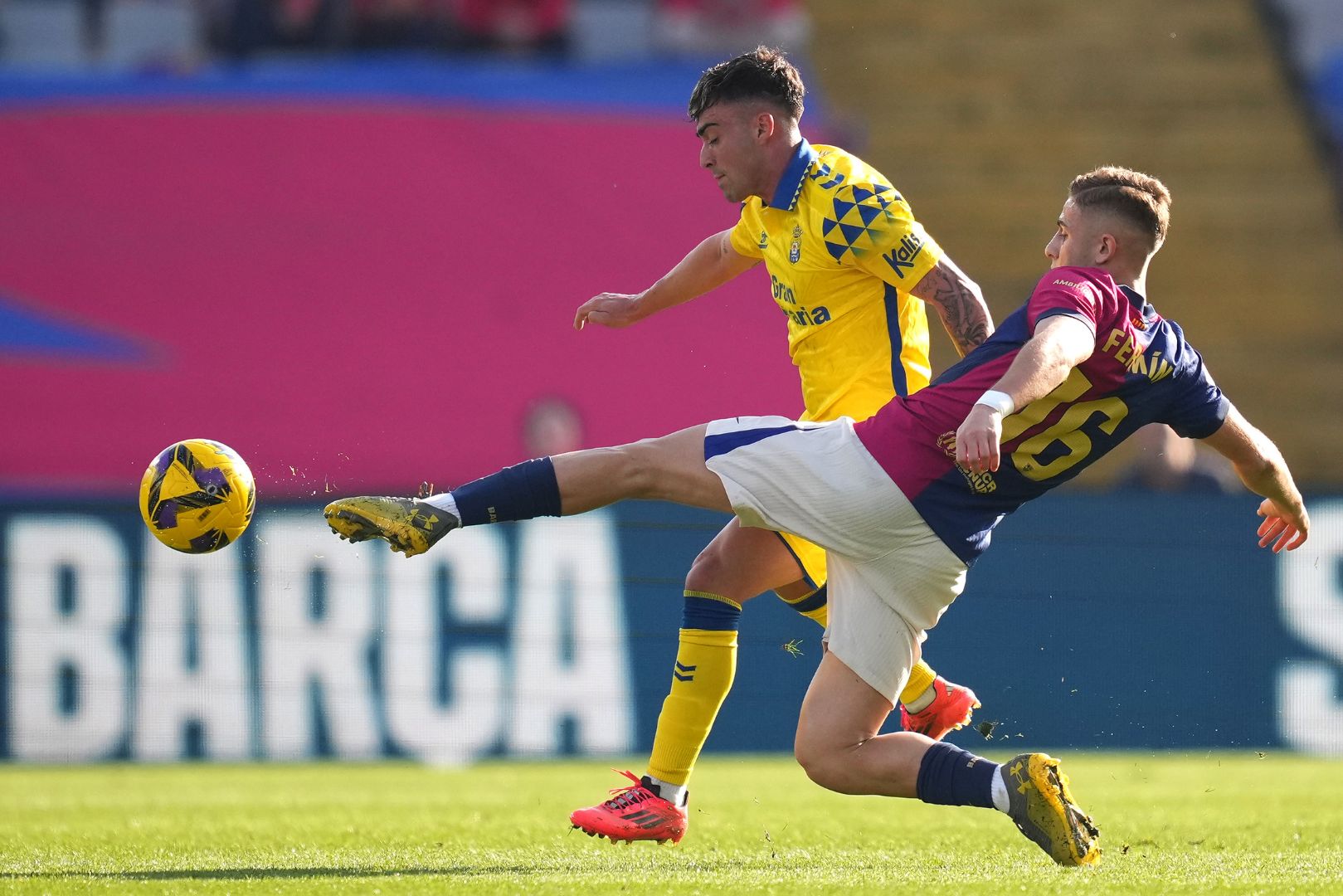 BARCELONA, SPAIN - NOVEMBER 30: Alberto Moleiro of UD Las Palmas is challenged by Fermin Lopez of FC Barcelona during the LaLiga match between FC Barcelona and UD Las Palmas at Estadi Olimpic Lluis Companys on November 30, 2024 in Barcelona, Spain.