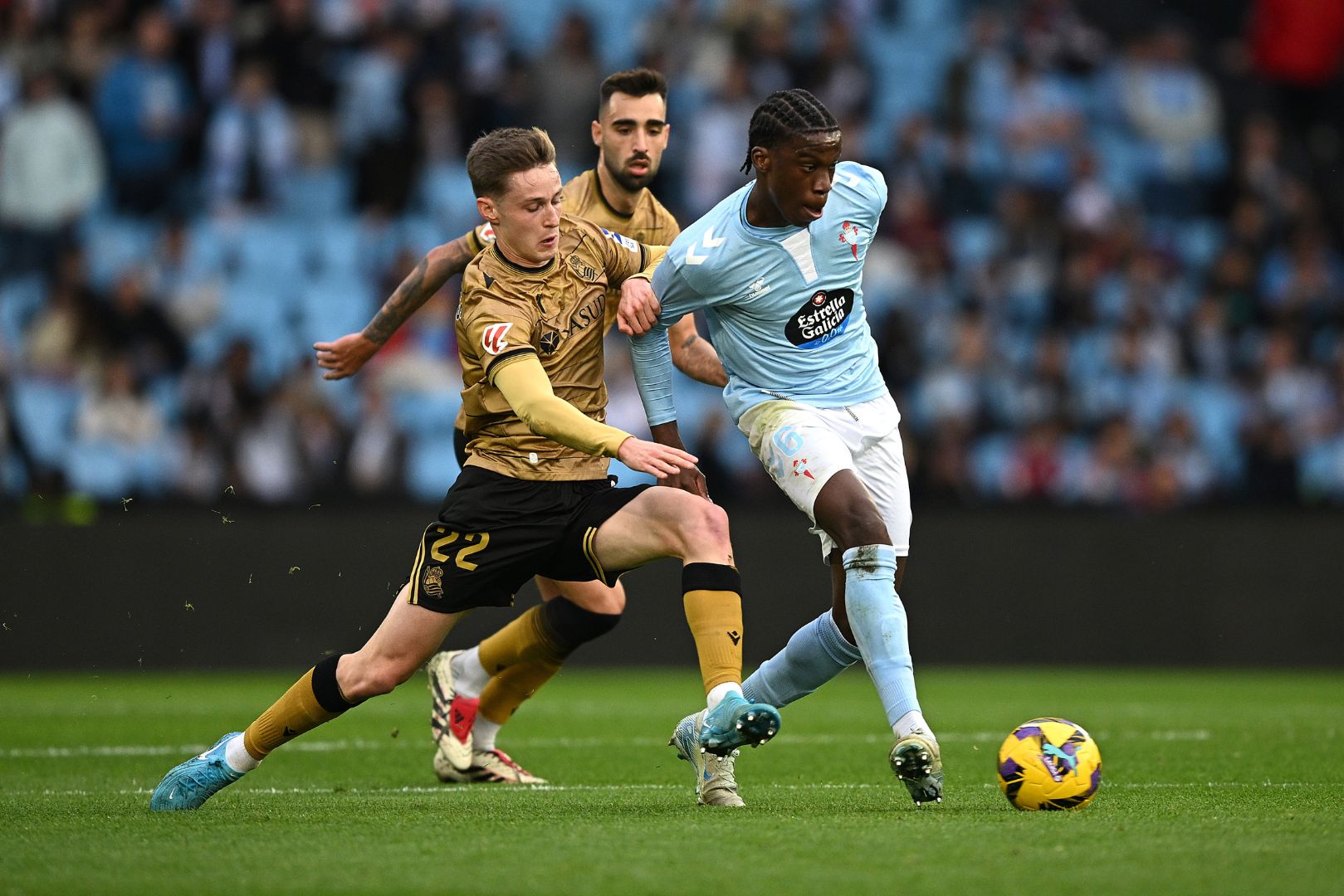 VIGO, SPAIN - DECEMBER 21: Ilaix Moriba of Celta Vigo is put under pressure by Benat Turrientes of Real Sociedad during the LaLiga match between RC Celta de Vigo and Real Sociedad at Estadio Balaidos on December 21, 2024 in Vigo, Spain.
