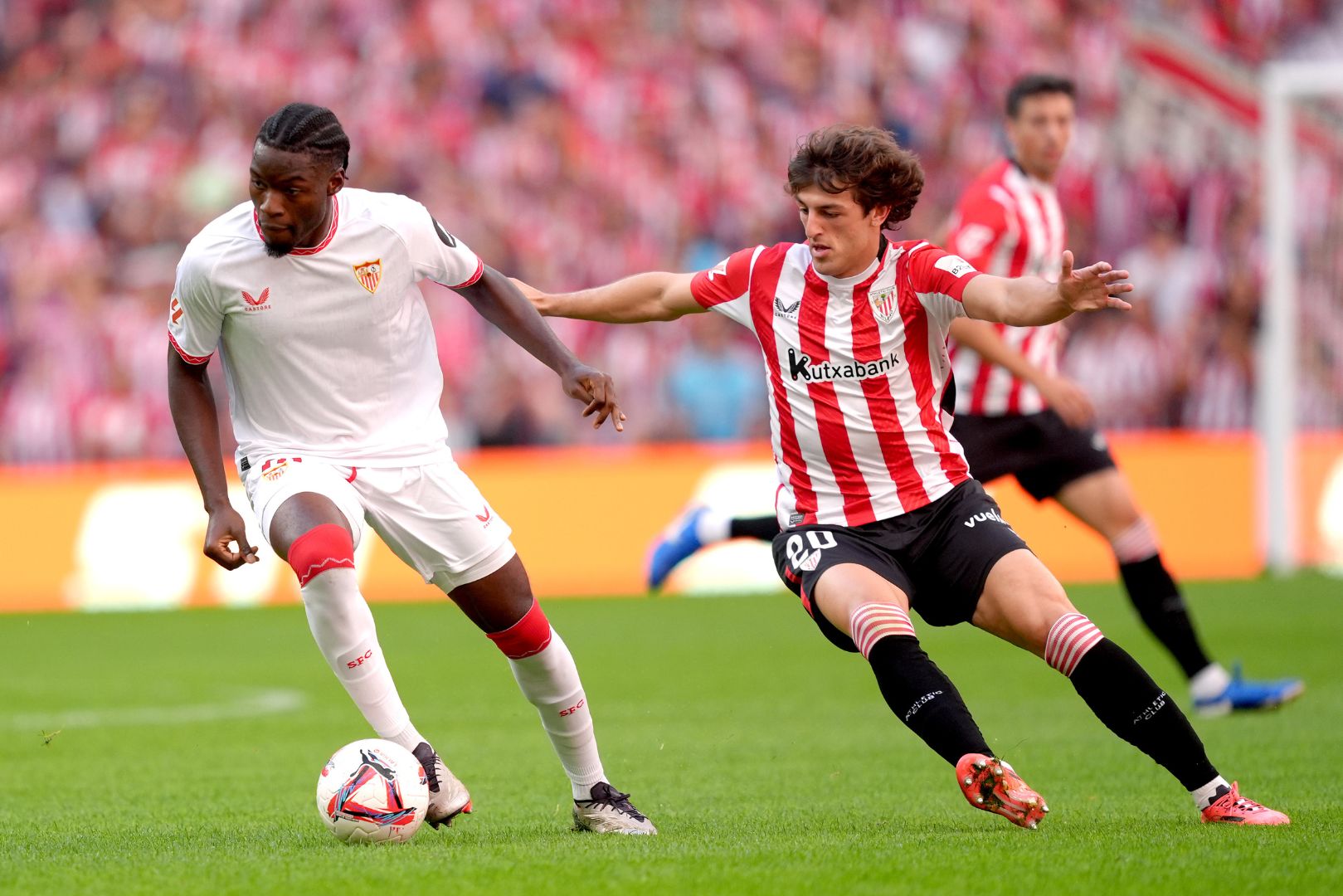 BILBAO, SPAIN - SEPTEMBER 29: Lucien Agoume of Sevilla FC battles for possession with Unai Gomez of Athletic Club during the LaLiga match between Athletic Club and Sevilla FC at Estadio de San Mames on September 29, 2024 in Bilbao, Spain.