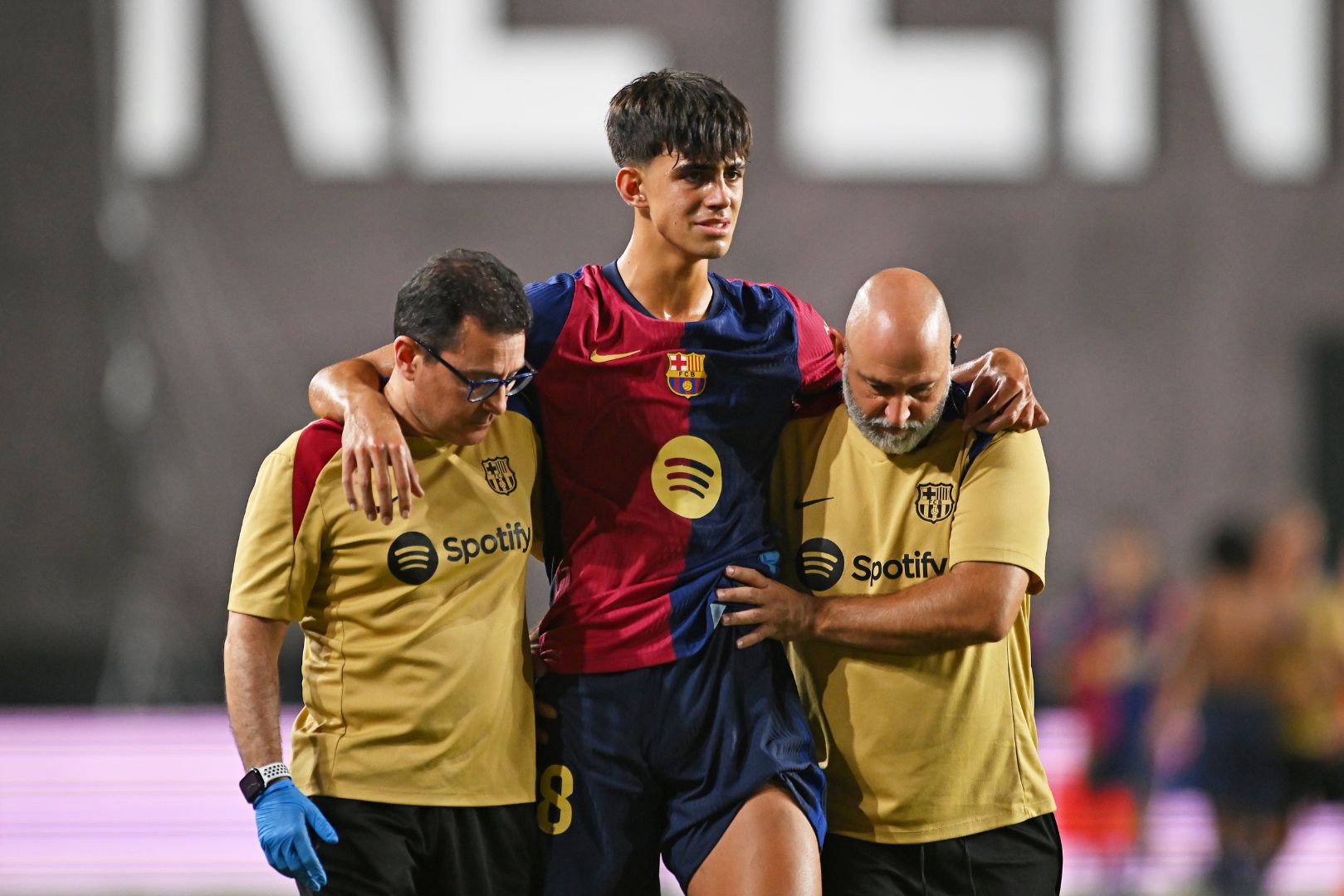 MADRID, SPAIN - AUGUST 27: Marc Bernal of FC Barcelona is helped from the pitch after getting injured during the La Liga match between Rayo Vallecano and FC Barcelona at Estadio de Vallecas on August 27, 2024 in Madrid, Spain.