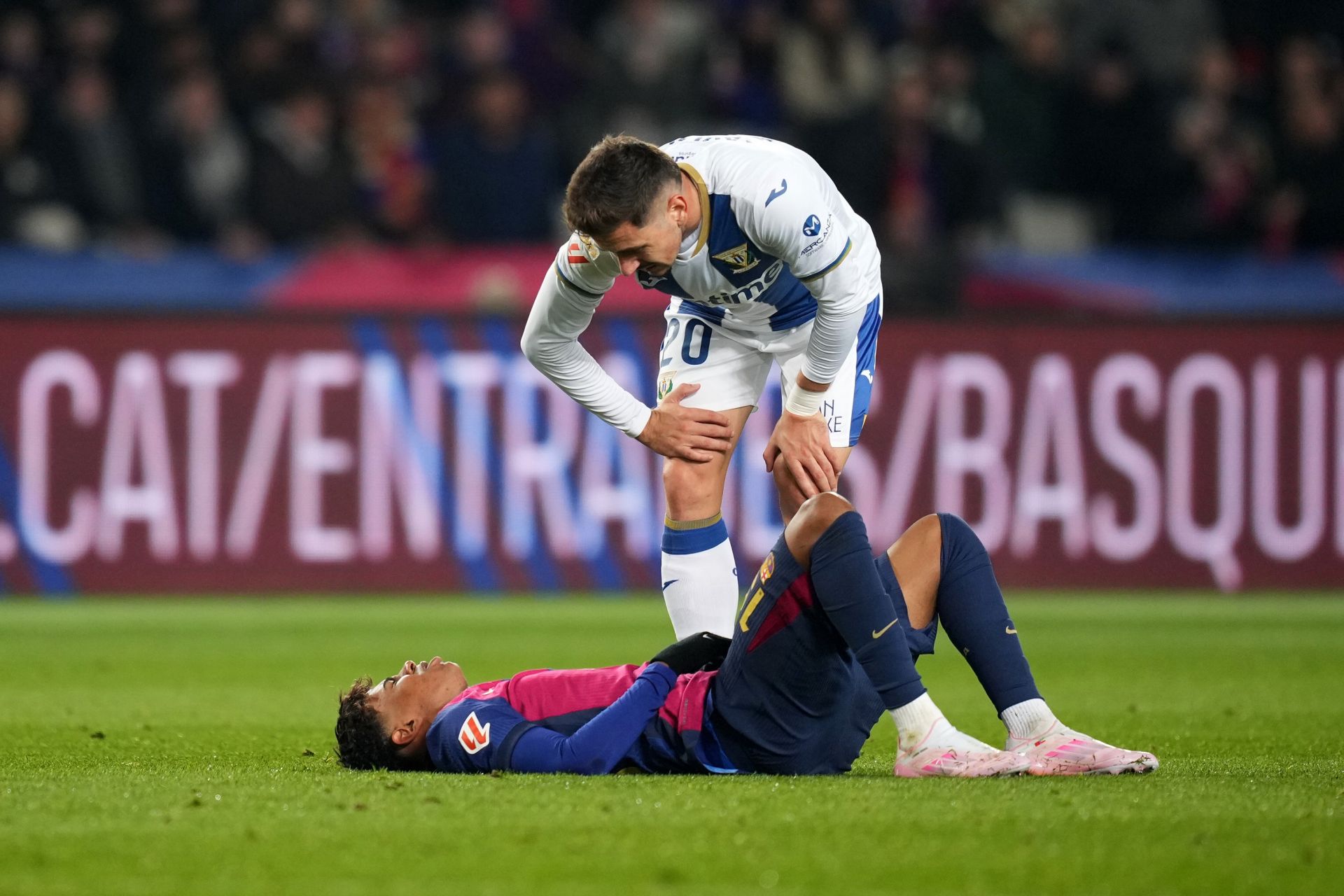 BARCELONA, SPAIN - DECEMBER 15: Lamine Yamal of FC Barcelona goes down injured after a challenge by Javi Hernandez of CD Leganes during the LaLiga match between FC Barcelona and CD Leganes at Estadi Olimpic Lluis Companys on December 15, 2024 in Barcelona, Spain.