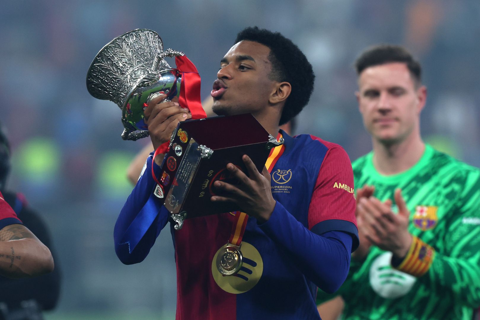 JEDDAH, SAUDI ARABIA - JANUARY 12: Alejandro Balde of FC Barcelona celebrates with the Supercopa de Espana winners' trophy during the trophy presentation after the Spanish Super Cup Final between Real Madrid and FC Barcelona at King Abdullah Sports City on January 12, 2025 in Jeddah, Saudi Arabia.