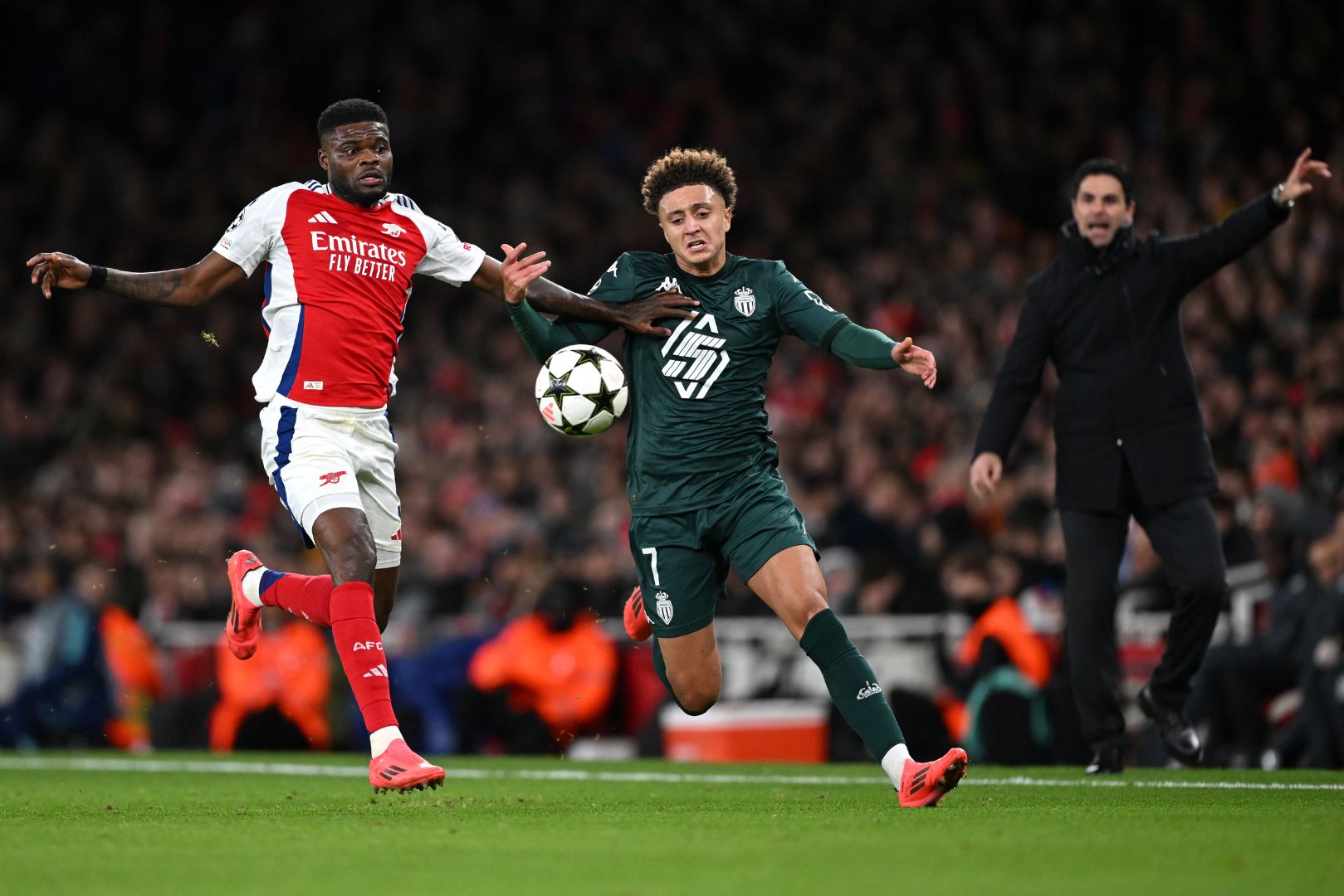 LONDON, ENGLAND - DECEMBER 11: Eliesse Ben Seghir of AS Monaco is challenged by Thomas Partey of Arsenal during the UEFA Champions League 2024/25 League Phase MD6 match between Arsenal FC and AS Monaco at Emirates Stadium on December 11, 2024 in London, England.