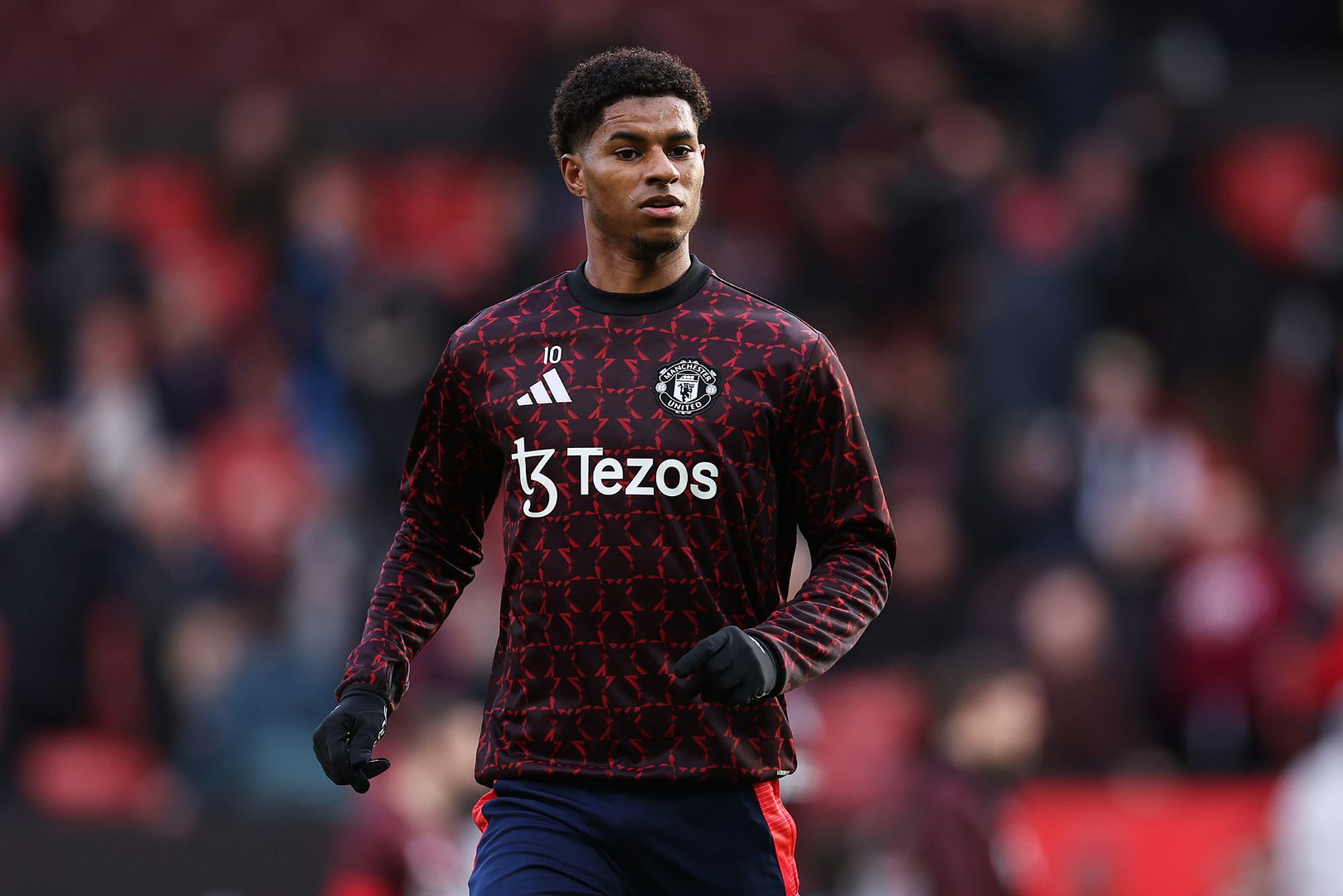 MANCHESTER, ENGLAND - DECEMBER 01: Marcus Rashford of Manchester United warms up prior to the Premier League match between Manchester United FC and Everton FC at Old Trafford on December 01, 2024 in Manchester, England.