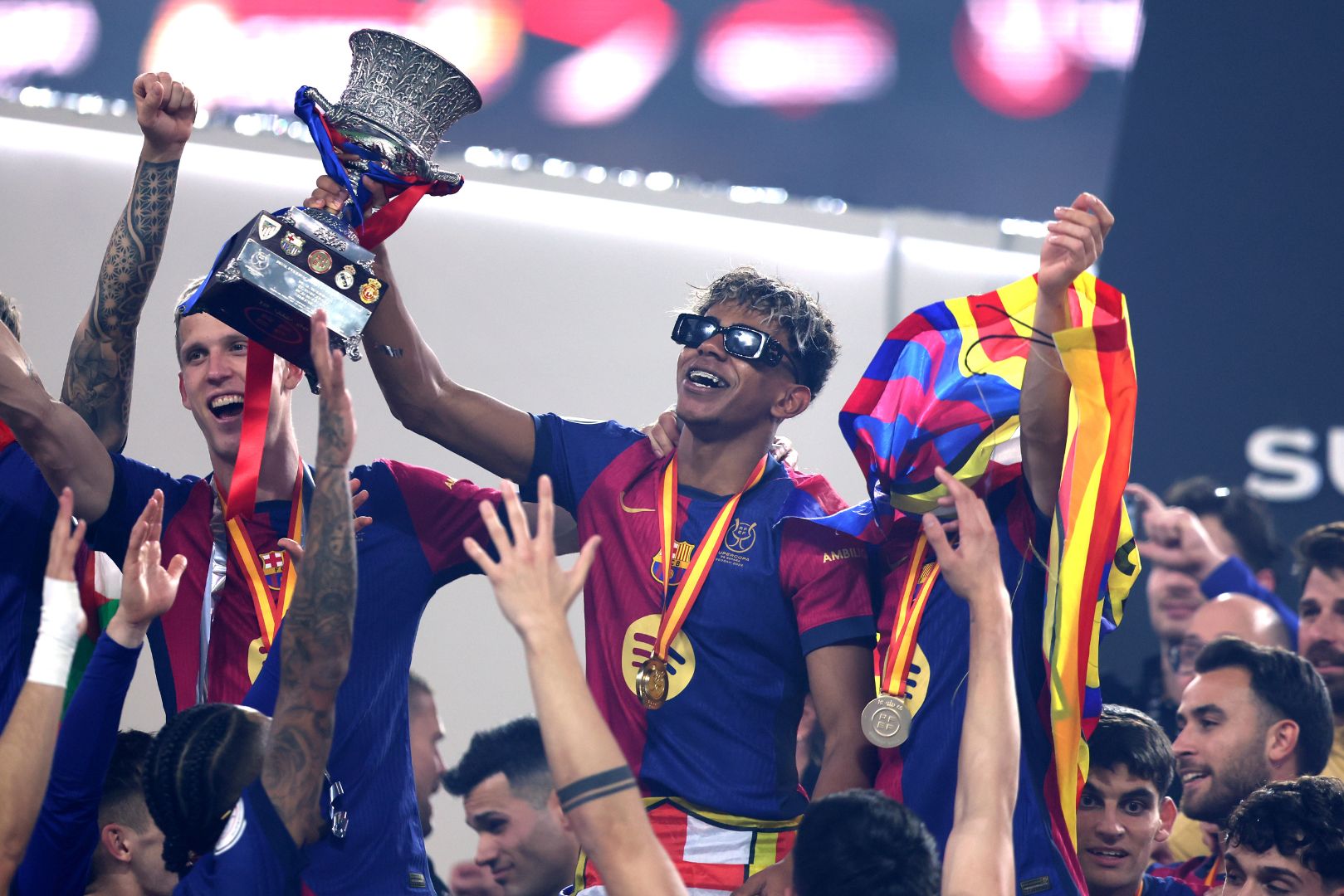 JEDDAH, SAUDI ARABIA - JANUARY 12: Lamine Yamal of FC Barcelona celebrates with the Supercopa de Espana trophy during the trophy presentation after the Spanish Super Cup Final between Real Madrid and FC Barcelona at King Abdullah Sports City on January 12, 2025 in Jeddah, Saudi Arabia.
