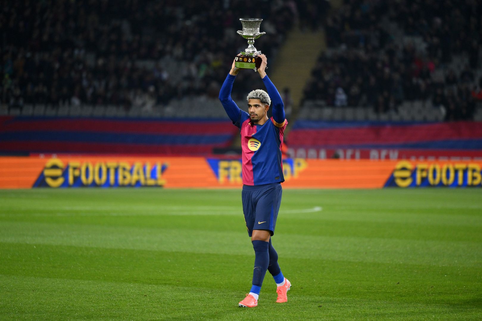 BARCELONA, SPAIN - JANUARY 15: Ronald Araujo of FC Barcelona holds the Supercopa de Espana trophy prior to kick-off ahead of the Copa del Rey Round of 16 match between FC Barcelona and Real Betis at Estadi Olimpic Lluis Companys on January 15, 2025 in Barcelona, Spain.