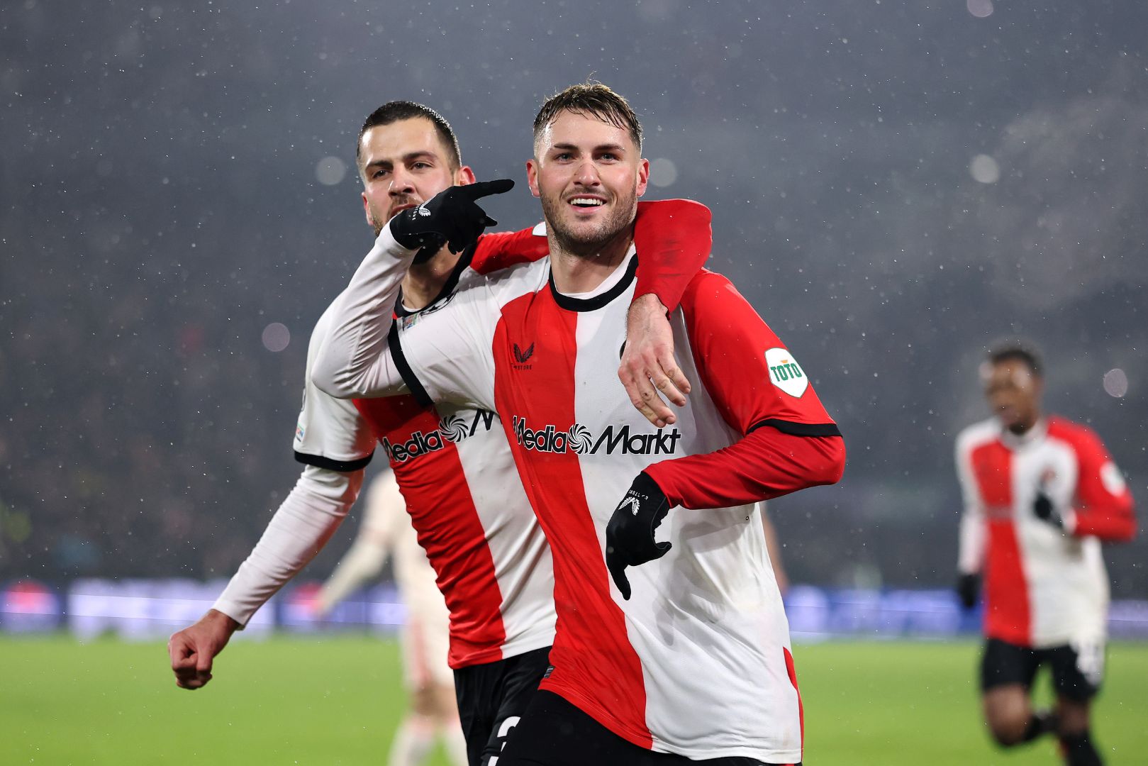 ROTTERDAM, NETHERLANDS - JANUARY 22: Santiago Gimenez of Feyenoord celebrates scoring his team's second goal with teammate David Hancko during the UEFA Champions League 2024/25 League Phase MD7 match between Feyenoord and FC Bayern München at De Kuip on January 22, 2025 in Rotterdam, Netherlands.