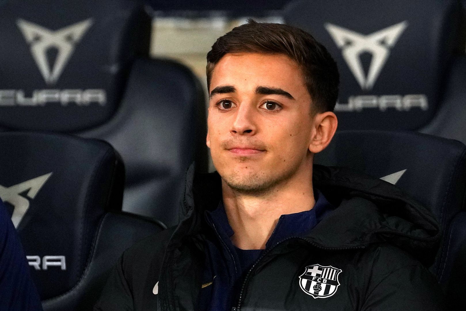 BARCELONA, SPAIN - FEBRUARY 25: Gavi of FC Barcelona looks on, while sitting on the bench during the Copa del Rey Semi Final match between FC Barcelona and Atletico de Madrid at Estadi Olimpic Lluis Companys on February 25, 2025 in Barcelona, Spain.
