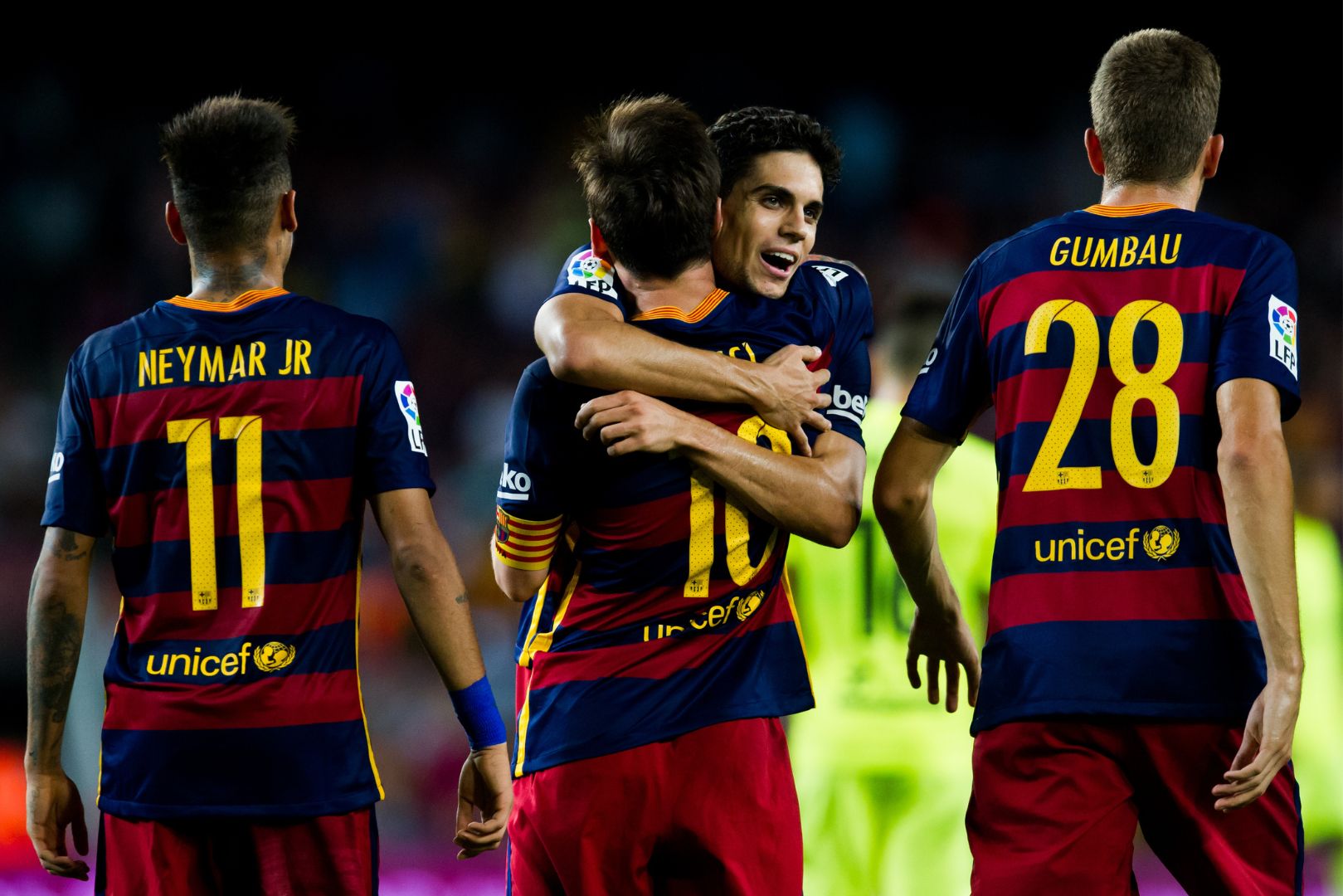 BARCELONA, SPAIN - SEPTEMBER 20: Lionel Messi of FC Barcelona celebrates with his teammates Neymar Santos Jr (L), Marc Bartra (2nd R) and Gerard Gumbau (R) after scoring his team's fourth goal during the La Liga match between FC Barcelona and Levante UD at Camp Nou on September 20, 2015 in Barcelona, Spain.