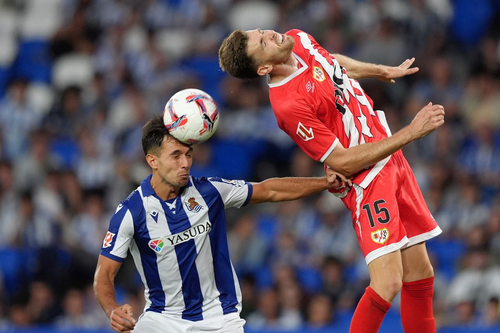 SAN SEBASTIAN, SPAIN - AUGUST 18: Martin Zubimendi of Real Sociedad and Gerard Gumbau of Rayo Vallecano battle for a header during the La Liga match between Real Sociedad de Fútbol and Rayo Vallecano de Madrid at Reale Arena on August 18, 2024 in San Sebastian, Spain.