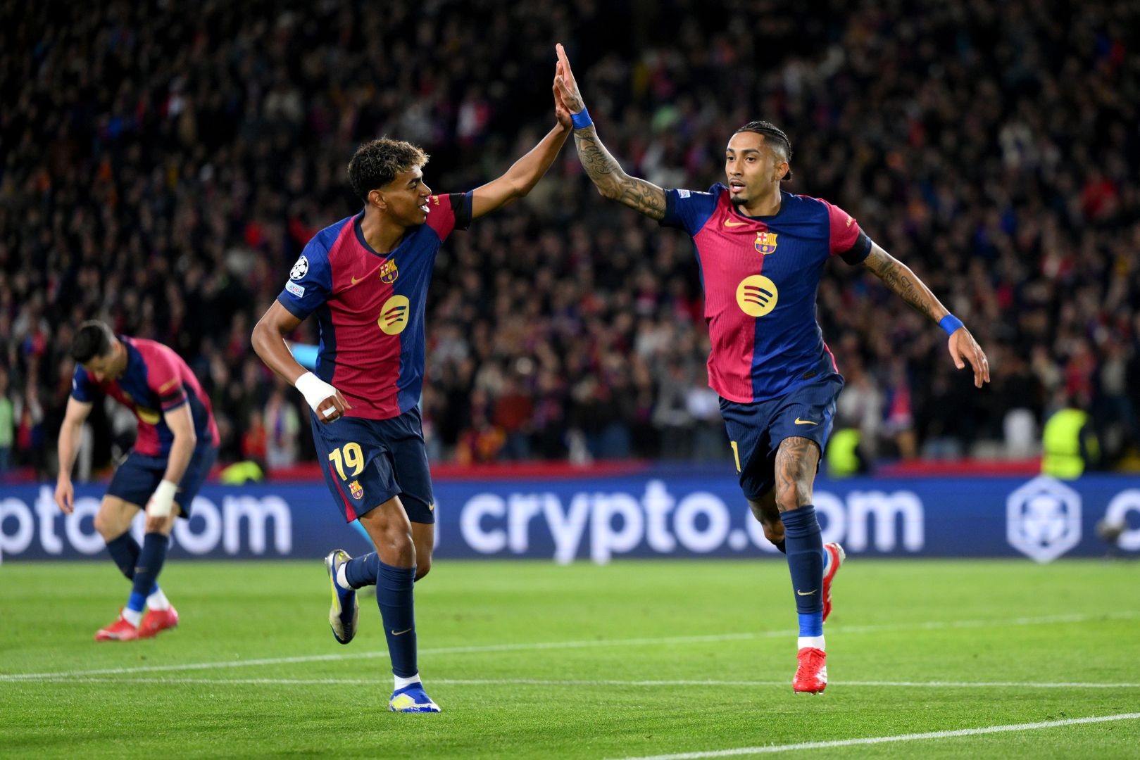 BARCELONA, SPAIN - MARCH 11: Raphinha of FC Barcelona celebrates scoring his team's third goal with teammate Lamine Yamal during the UEFA Champions League 2024/25 UEFA Champions League 2024/25 Round of 16 Second Leg match between FC Barcelona and SL Benfica at Estadi Olímpic Lluís Companys on March 11, 2025 in Barcelona, Spain.