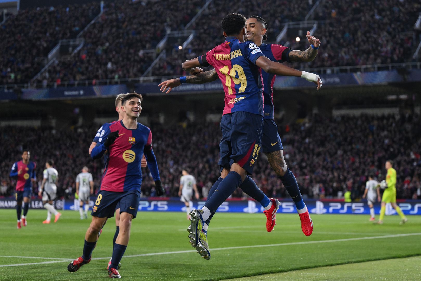 BARCELONA, SPAIN - MARCH 11: Raphinha of FC Barcelona celebrates scoring his team's first goal with teammate Lamine Yamal during the UEFA Champions League 2024/25 UEFA Champions League 2024/25 Round of 16 Second Leg match between FC Barcelona and SL Benfica at Estadi Olímpic Lluís Companys on March 11, 2025 in Barcelona, Spain.