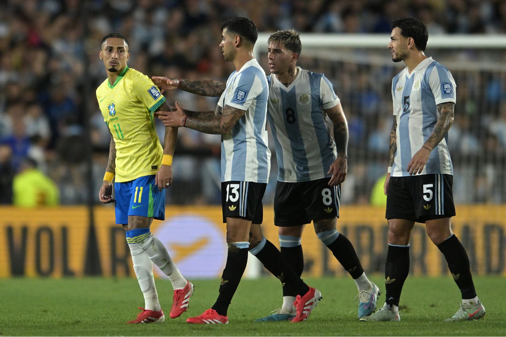 BUENOS AIRES, ARGENTINA - MARCH 25: Raphinha of Brazil reacts to Cristian Romero of Argentina during the South of American FIFA World Cup 2026 Qualifier between Argentina and Brazil at Estadio Más Monumental Antonio Vespucio Liberti on March 25, 2025 in Buenos Aires, Argentina.