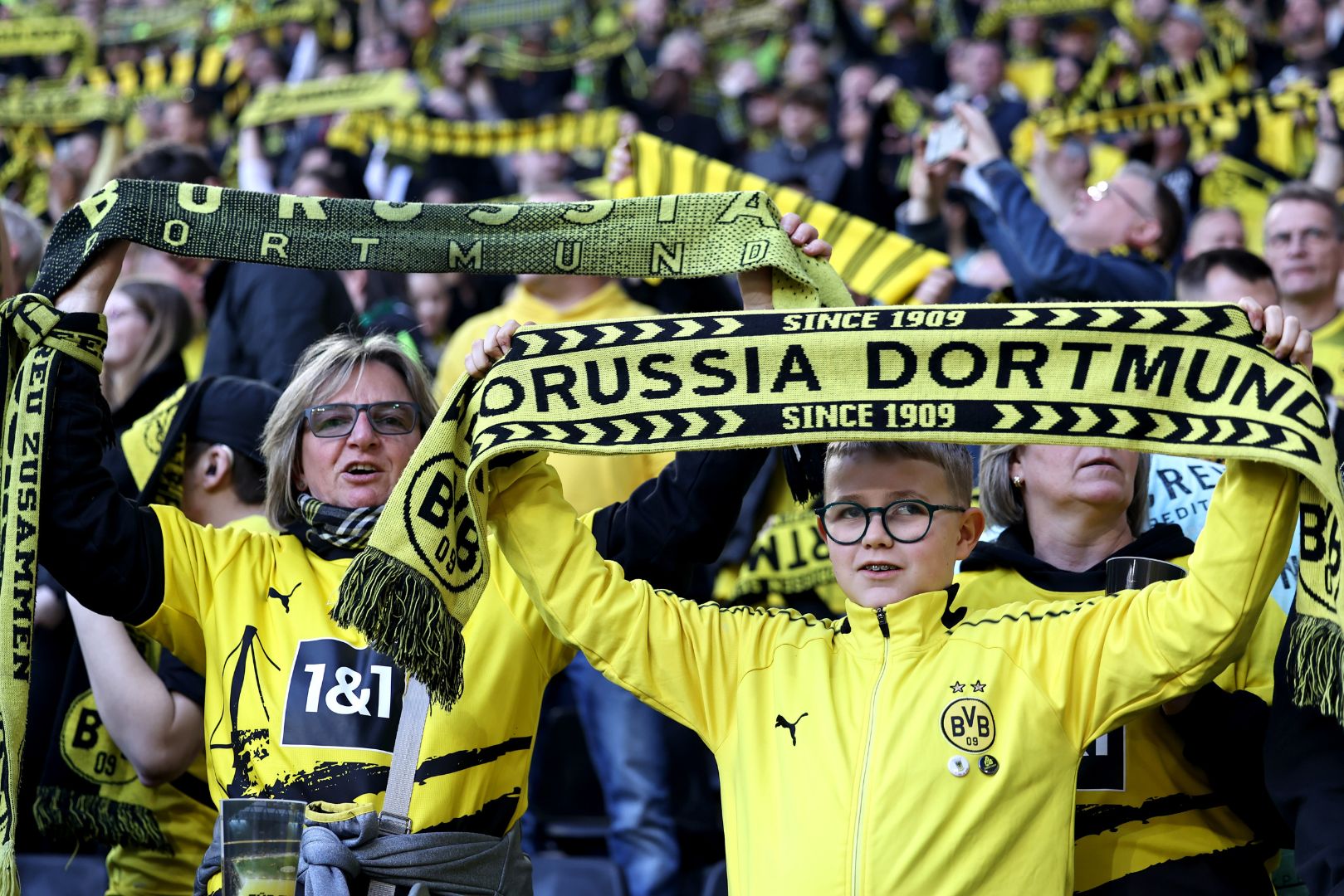 DORTMUND, GERMANY - MARCH 08: Fans of Borussia Dortmund hold up scarfs in the stands prior to the Bundesliga match between Borussia Dortmund and FC Augsburg at the Signal Iduna Park on March 08, 2025 in Dortmund, Germany.