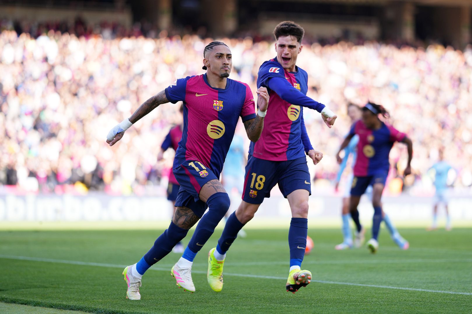 BARCELONA, SPAIN - APRIL 19: Raphinha of FC Barcelona celebrates scoring his team's fourth goal which was taken from the penalty spot with Pau Victor during the La Liga match between FC Barcelona and RC Celta de Vigo at Estadi Olimpic Lluis Companys on April 19, 2025 in Barcelona, Spain.