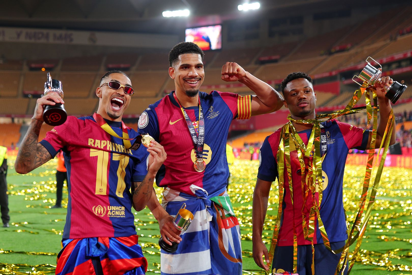 SEVILLE, SPAIN - APRIL 26: Raphinha, Ronald Araujo and Ansu Fati of FC Barcelona celebrate after the team's victory in the Copa del Rey Final match between FC Barcelona and Real Madrid at Estadio de La Cartuja on April 26, 2025 in Seville, Spain.