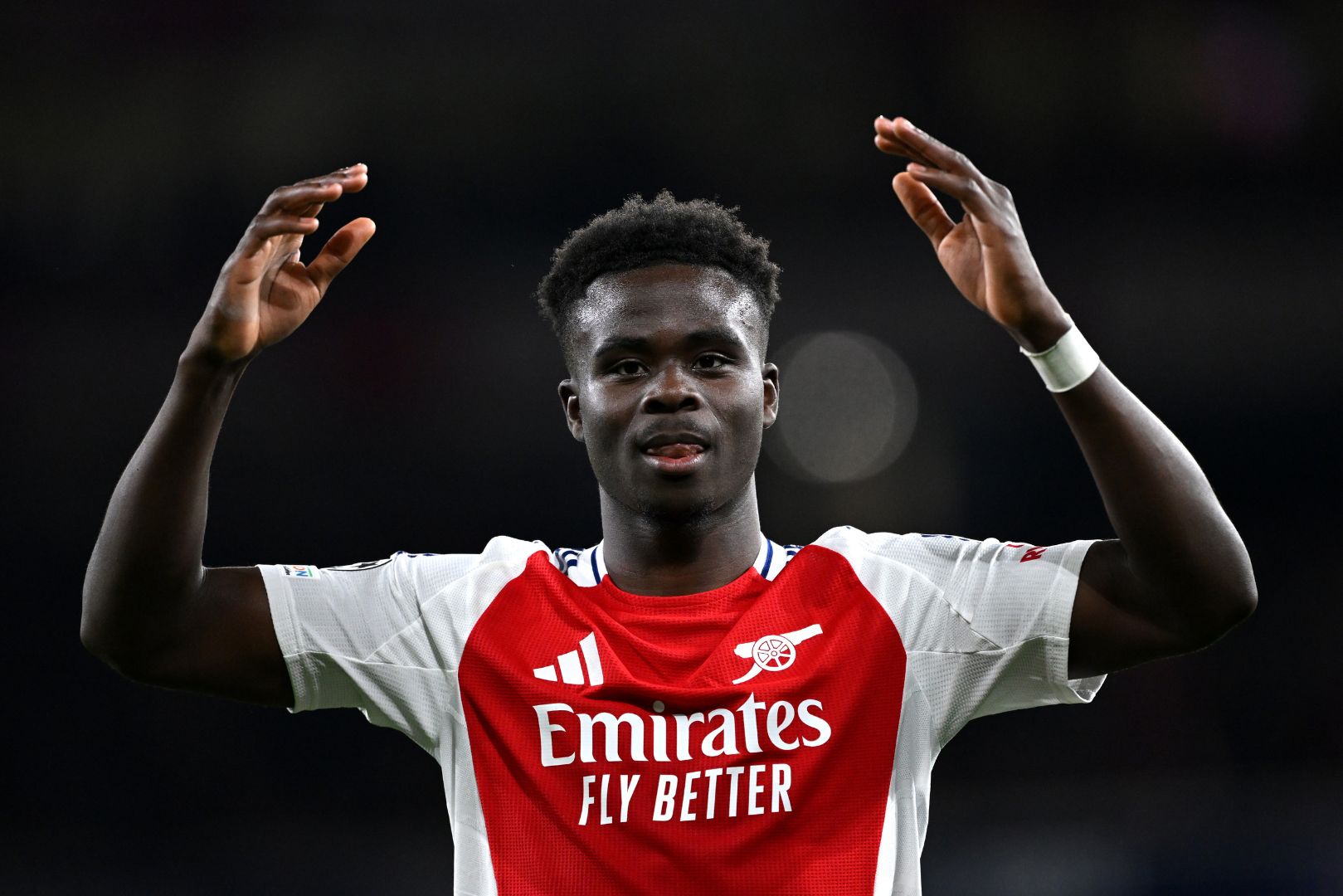 LONDON, ENGLAND - APRIL 08: Bukayo Saka of Arsenal encourages the fans during the UEFA Champions League 2024/25 Quarter Final First Leg match between Arsenal FC and Real Madrid C.F. at Emirates Stadium on April 08, 2025 in London, England.