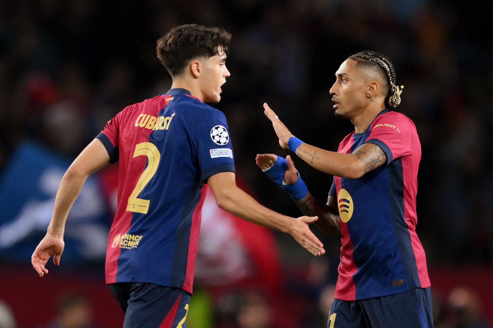 BARCELONA, SPAIN - APRIL 30: Raphinha of FC Barcelona (R) celebrates with team mate Pau Cubarsi after their team's third goal, an own goal scored by Yann Sommer of FC Internazionale (not pictured) during the UEFA Champions League 2024/25 Semi Final First Leg match between FC Barcelona and FC Internazionale Milano at Estadi Olimpic Lluis Companys on April 30, 2025 in Barcelona, Spain.