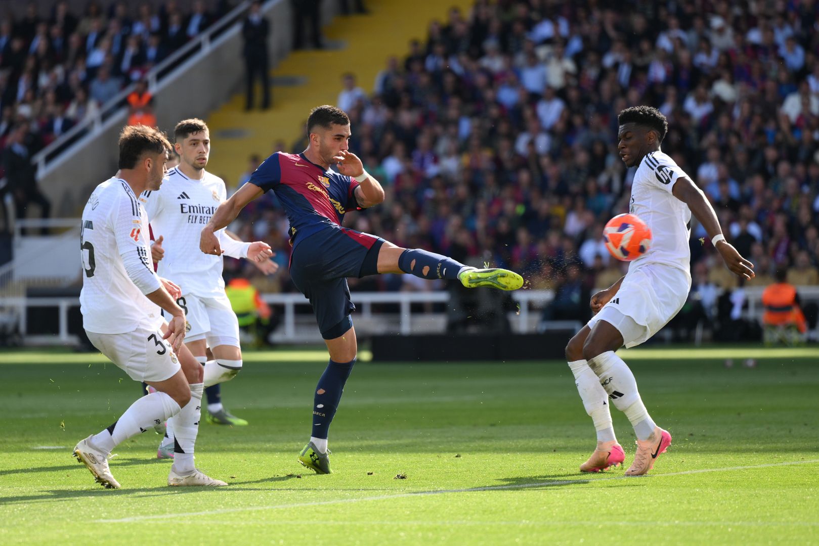 BARCELONA, SPAIN - MAY 11: Ferran Torres of FC Barcelona shoots, under pressure from Aurelien Tchouameni of Real Madrid, which resulted in VAR checking for a possible handball during the LaLiga match between FC Barcelona and Real Madrid CF at Estadi Olimpic Lluis Companys on May 11, 2025 in Barcelona, Spain.