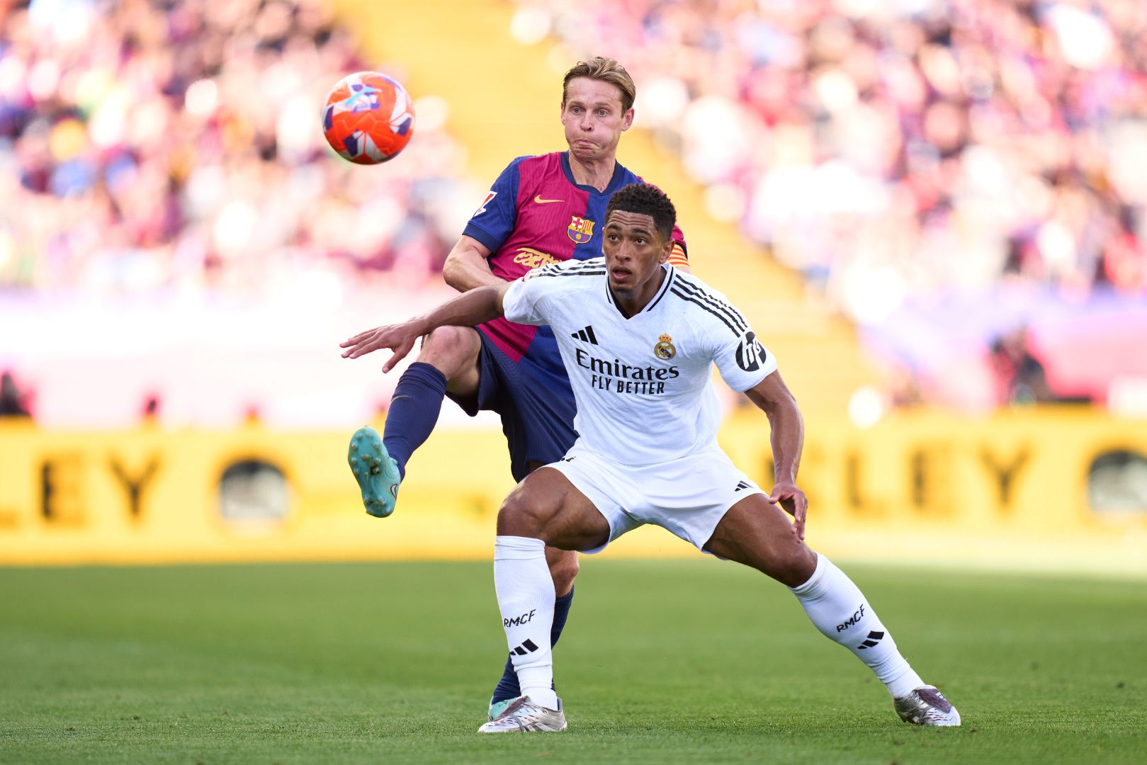 BARCELONA, SPAIN - MAY 11: Frenkie De Jong of FC Barcelona and Jude Bellingham of Real Madrid CF fight for the ball during the LaLiga match between FC Barcelona and Real Madrid CF at Estadi Olimpic Lluis Companys on May 11, 2025 in Barcelona, Spain.