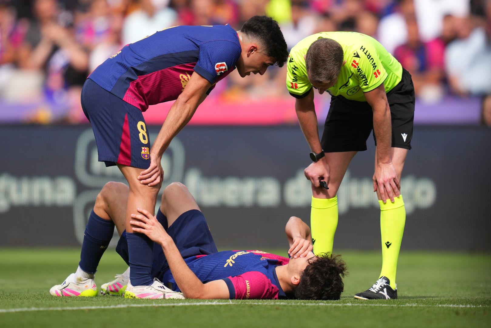 BARCELONA, SPAIN - MAY 11: Pau Cubarsi of FC Barcelona reacts on the floor, as his teammate Pedri and referee Alejandro Jose Hernandez Hernandez looks on during the LaLiga match between FC Barcelona and Real Madrid CF at Estadi Olimpic Lluis Companys on May 11, 2025 in Barcelona, Spain.