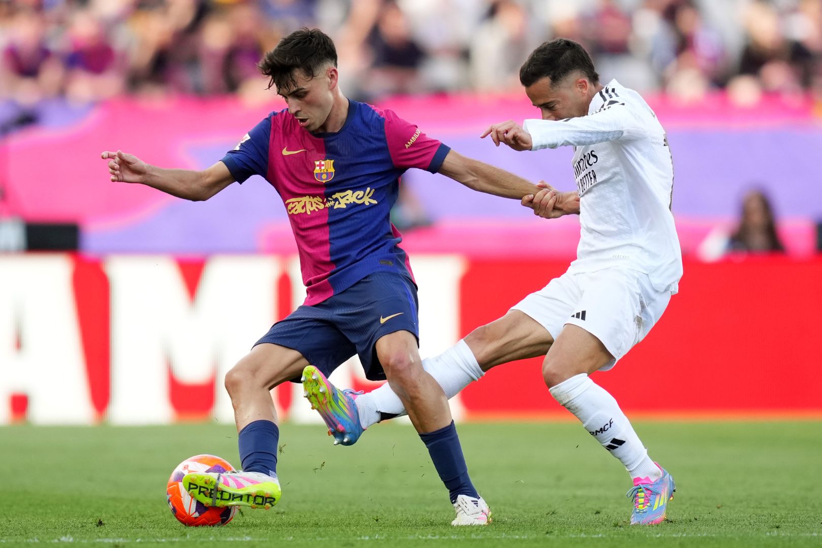 BARCELONA, SPAIN - MAY 11: Pedri of FC Barcelona is challenged by Lucas Vazquez of Real Madrid during the LaLiga match between FC Barcelona and Real Madrid CF at Estadi Olimpic Lluis Companys on May 11, 2025 in Barcelona, Spain.