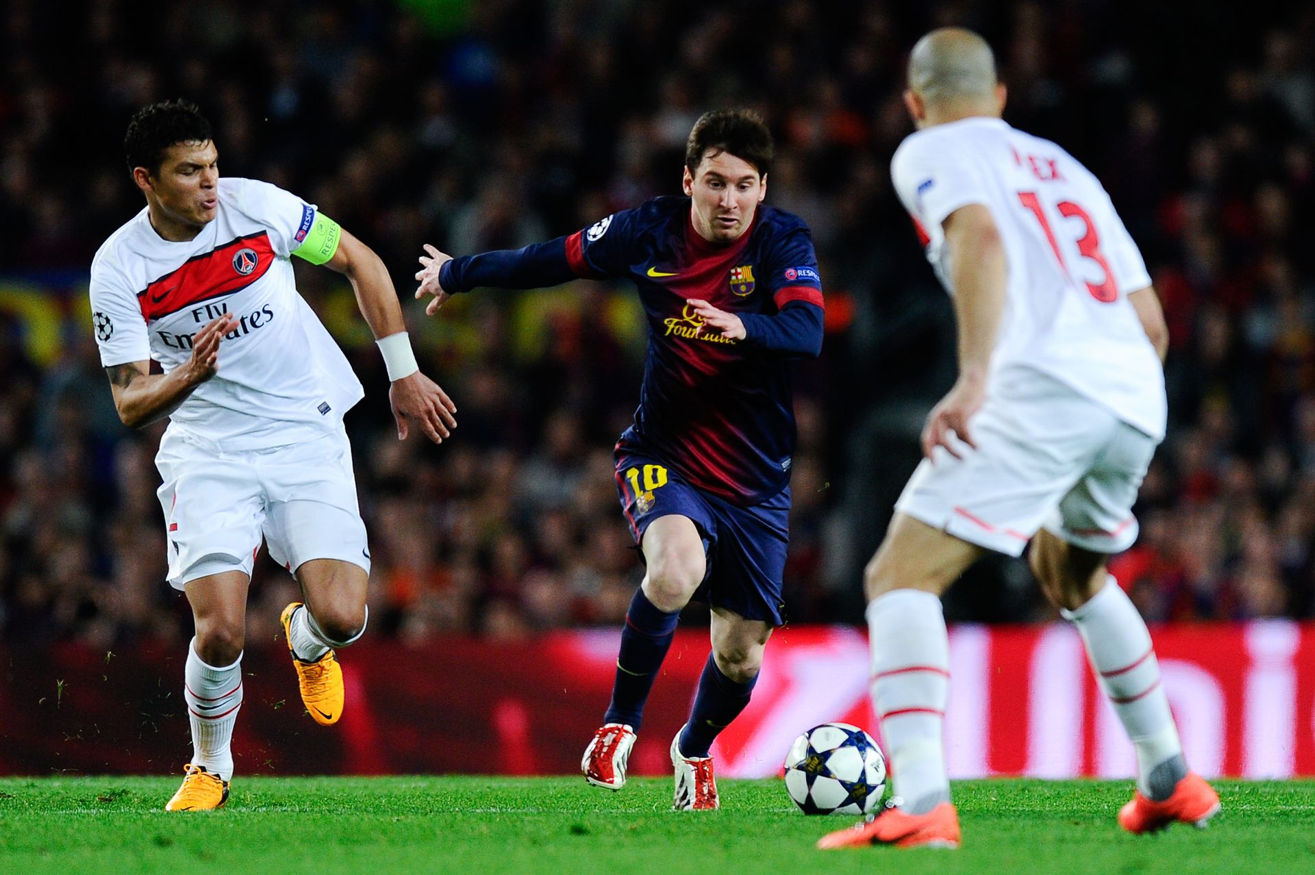 BARCELONA, SPAIN - APRIL 10: Lionel Messi of FC Barcelona duels for the ball with Thiago Silva of Paris Saint-Germain and Alex of Paris Saint-Germain during the UEFA Champions League quarter-final second leg match between Barcelona and Paris St Germain at Nou Camp on April 10, 2013 in Barcelona, Spain.