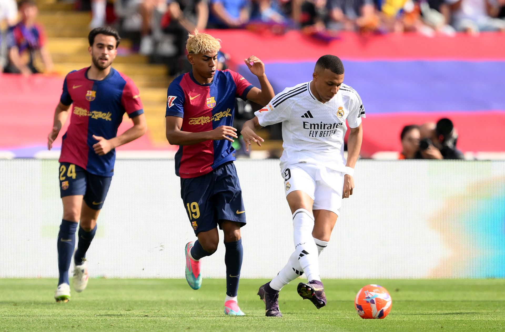 BARCELONA, SPAIN - MAY 11: Kylian Mbappe of Real Madrid passes the ball under pressure from Lamine Yamal of FC Barcelona during the LaLiga match between FC Barcelona and Real Madrid CF at Estadi Olimpic Lluis Companys on May 11, 2025 in Barcelona, Spain.