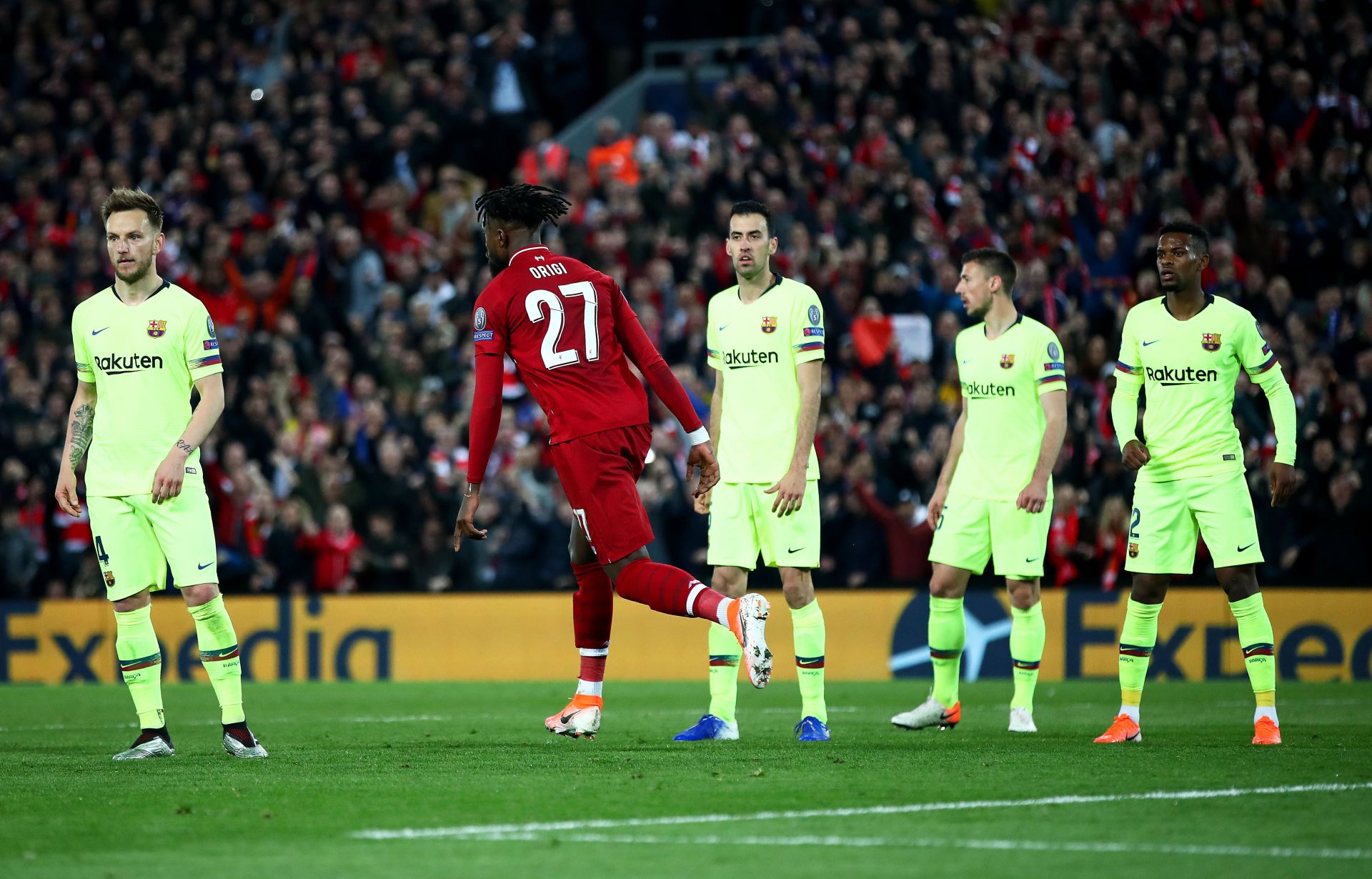 LIVERPOOL, ENGLAND - MAY 07: Divock Origi of Liverpool (27) celebrates after he scores his team's fourth goal as the Barcelona defence look on dejected during the UEFA Champions League Semi Final second leg match between Liverpool and Barcelona at Anfield on May 07, 2019 in Liverpool, England.