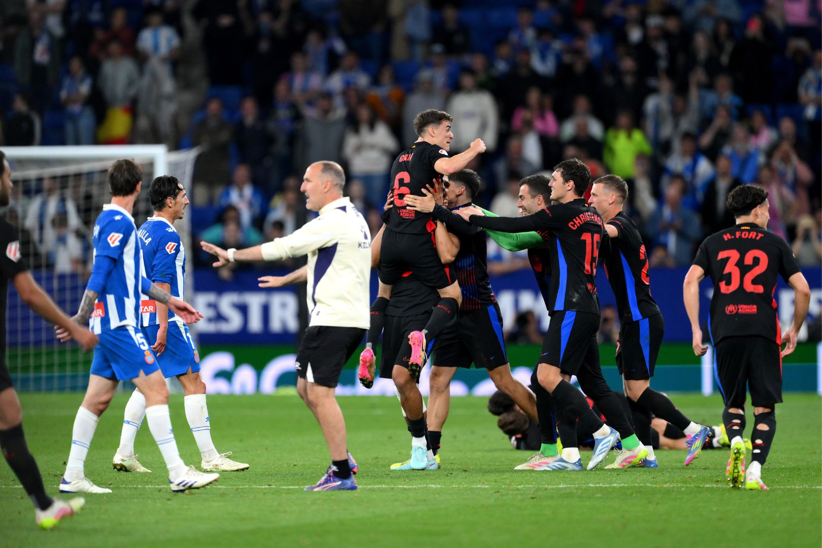 BARCELONA, SPAIN - MAY 15: Gavi of FC Barcelona celebrates with team mates Andreas Christensen, Gerard Martin and Dani Olmo following their team's victory and confirmation of winning the LaLiga title after the LaLiga match between RCD Espanyol de Barcelona and FC Barcelona at RCDE Stadium on May 15, 2025 in Barcelona, Spain.