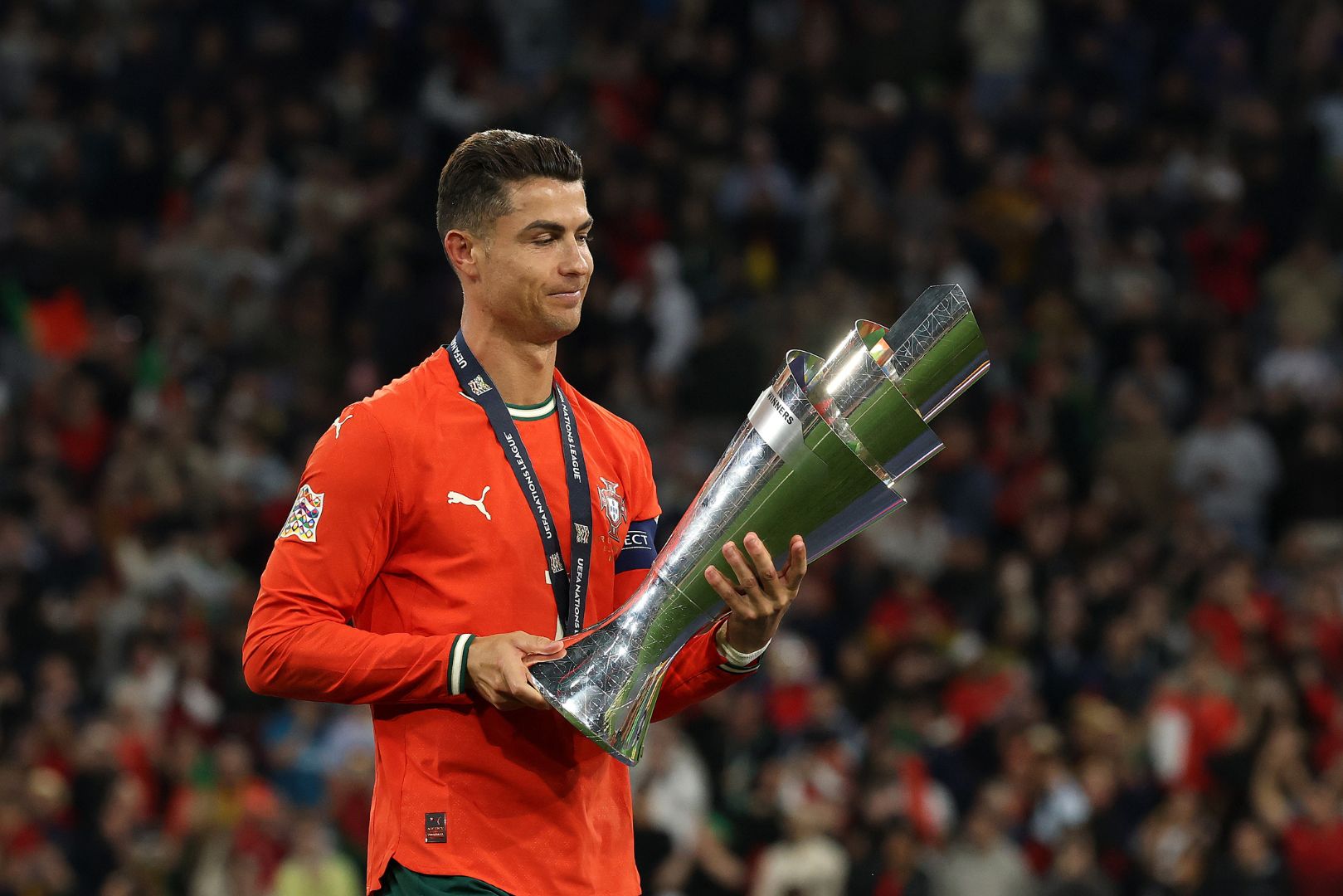 MUNICH, GERMANY - JUNE 08: Cristiano Ronaldo of Portugal holds the UEFA Nations League trophy after his team's victory in during the UEFA Nations League 2025 final match between Portugal and Spain at Munich Football Arena on June 08, 2025 in Munich, Germany.