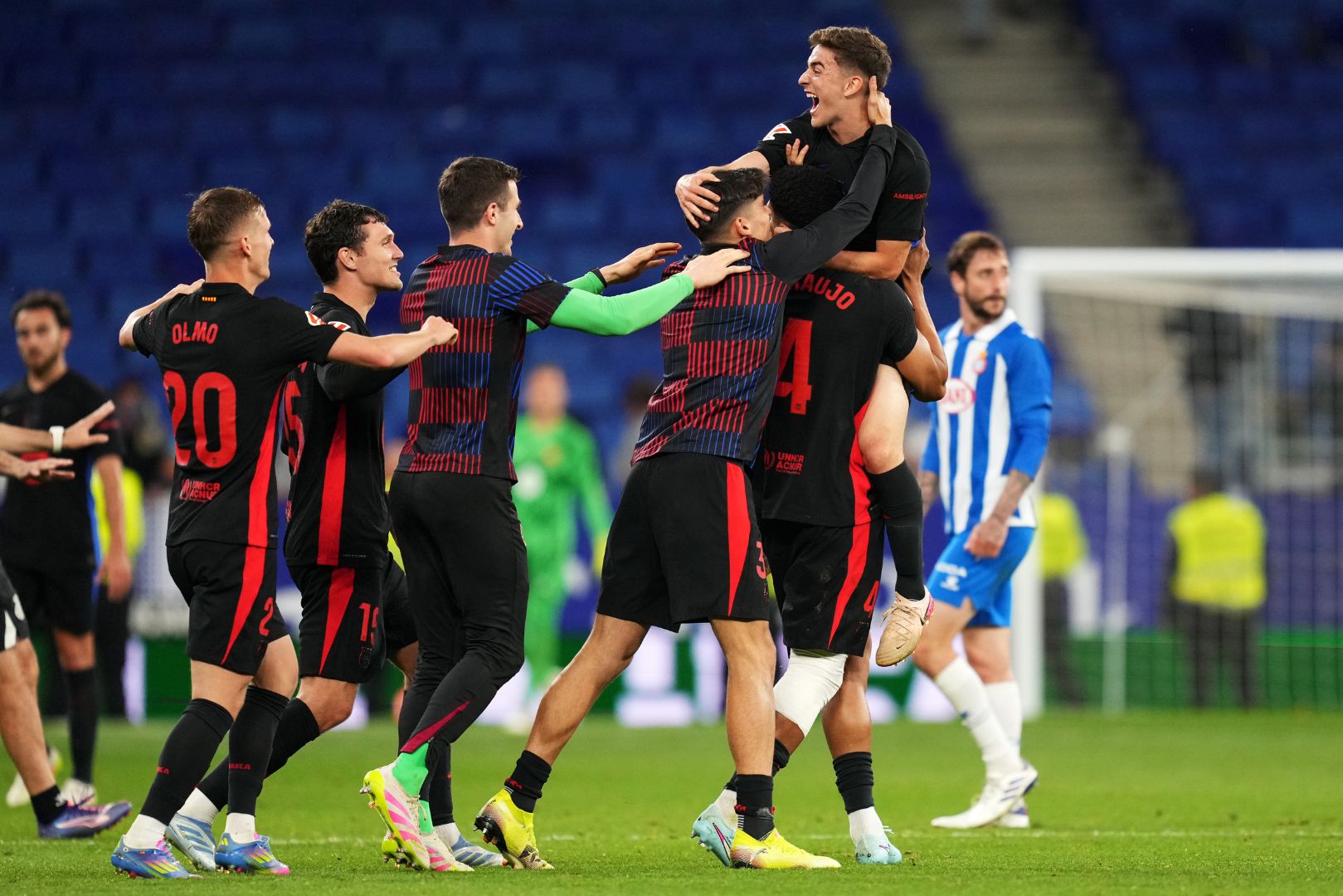 BARCELONA, SPAIN - MAY 15: Gavi of FC Barcelona celebrates with team mates Dani Olmo, Andreas Christensen, Gerard Martin and Ronald Araujo (obscured) following the team's victory and confirmation of winning the LaLiga title after the LaLiga match between RCD Espanyol de Barcelona and FC Barcelona at RCDE Stadium on May 15, 2025 in Barcelona, Spain.
