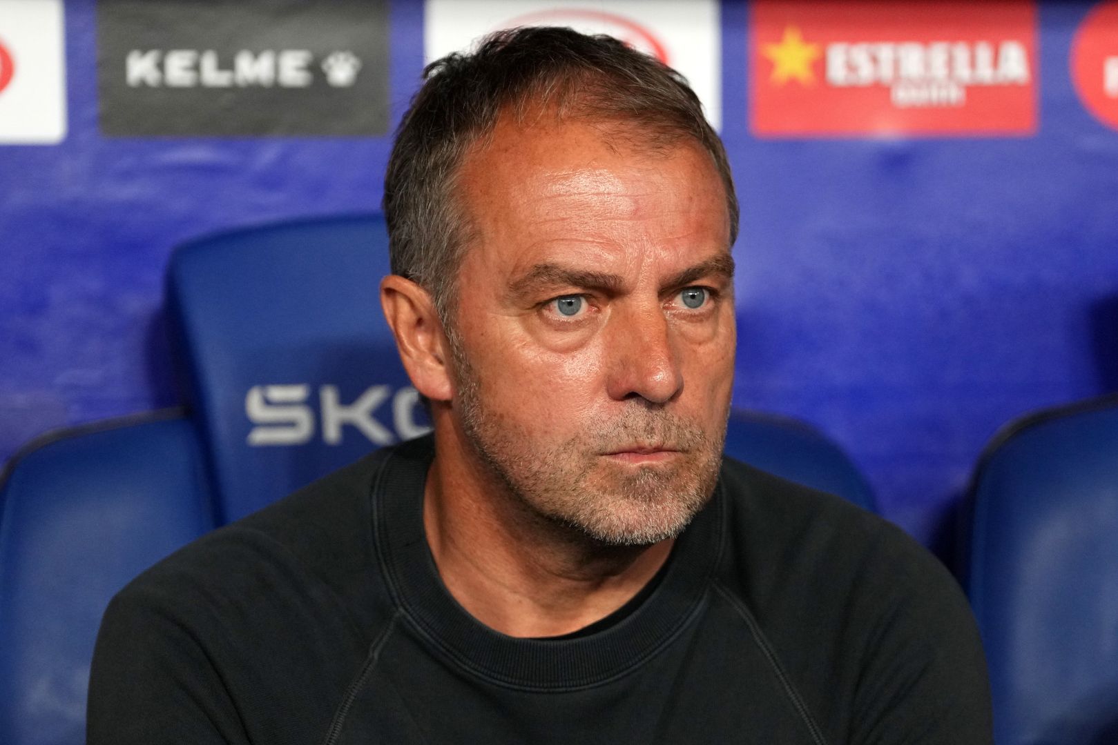 BARCELONA, SPAIN - MAY 15: Hansi Flick, Head Coach of FC Barcelona, looks on from the dugout prior to the LaLiga match between RCD Espanyol de Barcelona and FC Barcelona at RCDE Stadium on May 15, 2025 in Barcelona, Spain.