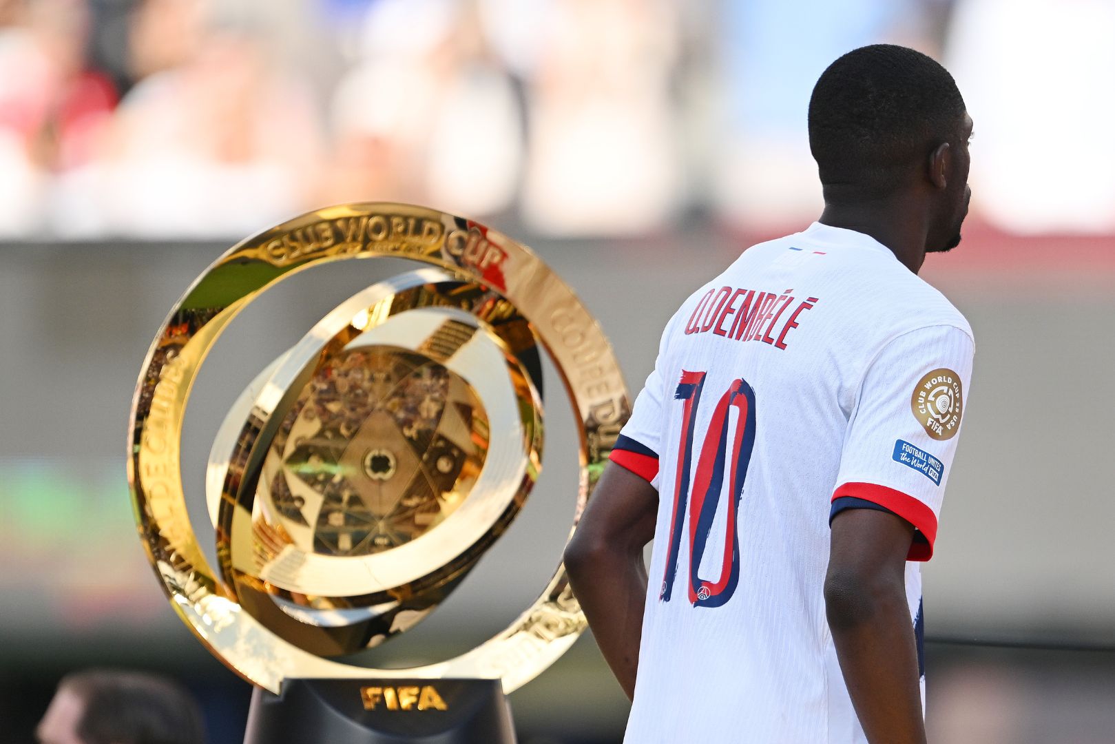 EAST RUTHERFORD, NEW JERSEY - JULY 13: Ousmane Dembele #10 of Paris Saint-Germain walks past the FIFA Club World Cup trophy after their team's defeat following the FIFA Club World Cup 2025 Final match between Chelsea FC and Paris Saint-Germain at MetLife Stadium on July 13, 2025 in East Rutherford, New Jersey.