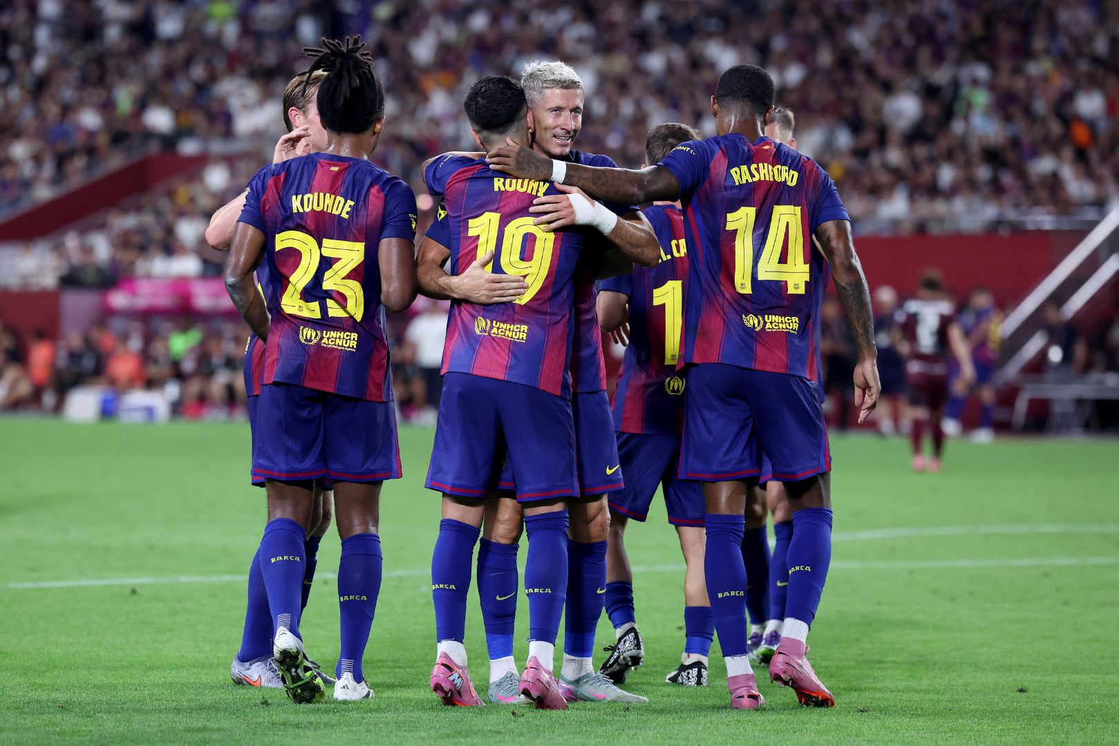 KOBE, JAPAN - JULY 27: FC Barcelona's Roony Bardghji (C) is congratulated by Robert Lewandowski after scoring a goal during the preseason friendly between Vissel Kobe and FC Barcelona at Noevir Stadium Kobe on July 27, 2025 in Kobe, Hyogo, Japan.