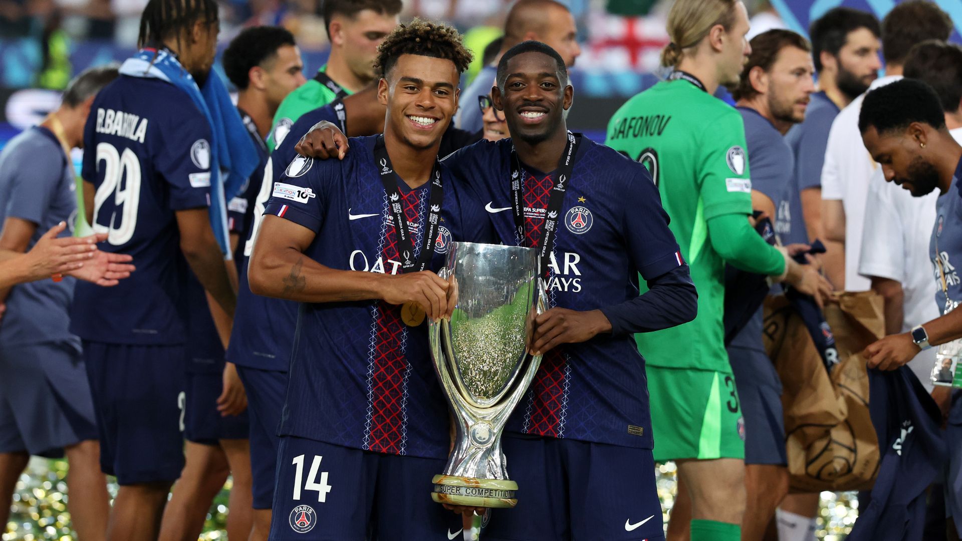 UDINE, ITALY - AUGUST 13: Desire Doue and Ousmane Dembele of Paris Saint-Germain pose for a photo with the UEFA Super Cup trophy after the team's victory in the UEFA Super Cup 2025 match between Paris Saint-Germain and Tottenham Hotspur at Stadio Friuli on August 13, 2025 in Udine, Italy.