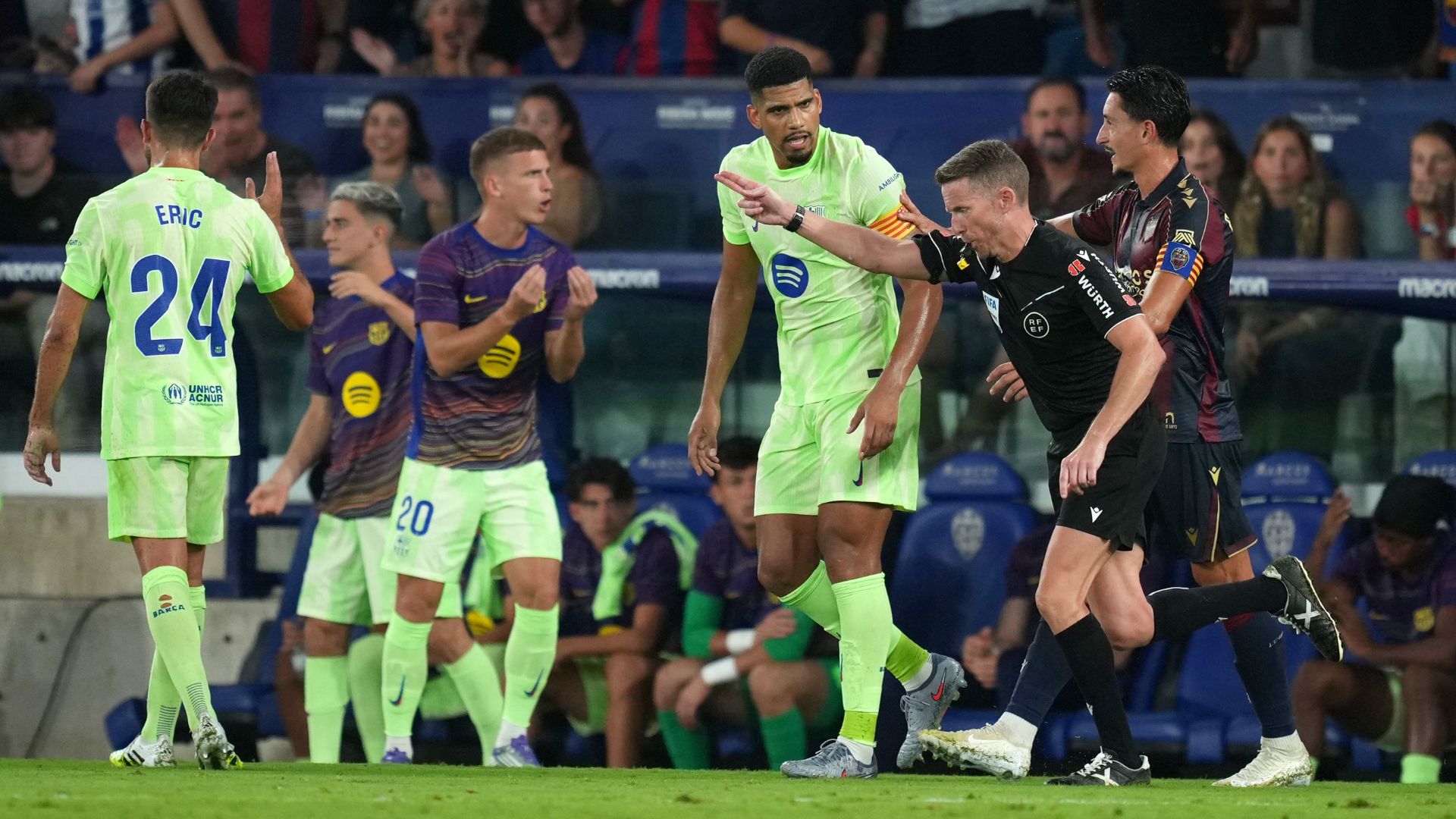 VALENCIA, SPAIN - AUGUST 23: Referee Alejandro Hernandez gestures for a penalty following a VAR review during a VAR review during the LaLiga EA Sports match between Levante UD and FC Barcelona at Ciutat de Valencia on August 23, 2025 in Valencia, Spain.