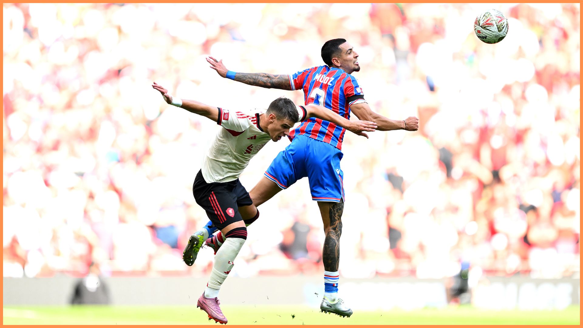 Milos Kerkez of Liverpool battles for possession with Daniel Munoz of Crystal Palace during the 2025 FA Community Shield match between Crystal Palace and Liverpool at Wembley Stadium.