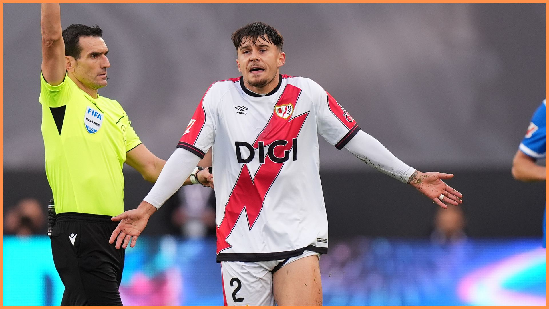 MADRID, SPAIN - NOVEMBER 09: Andrei Ratiu of Rayo Vallecano is shown a yellow card by referee Juan Martinez Munuera during the LaLiga EA Sports match between Rayo Vallecano de Madrid and Real Madrid CF at Estadio de Vallecas on November 09, 2025 in Madrid, Spain.