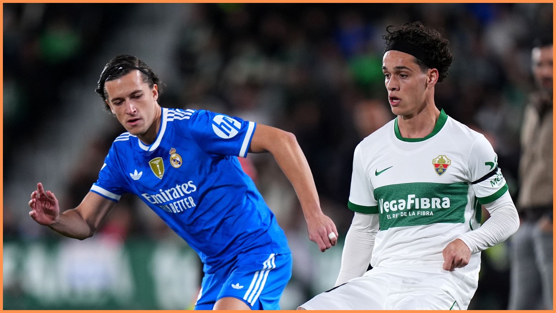 ELCHE, SPAIN - NOVEMBER 23: Hector Fort of Elche CF passes the ball whilst under pressure from Alvaro Carreras of Real Madrid during the LaLiga EA Sports match between Elche CF and Real Madrid CF at Estadio Manuel Martinez Valero on November 23, 2025 in Elche, Spain.