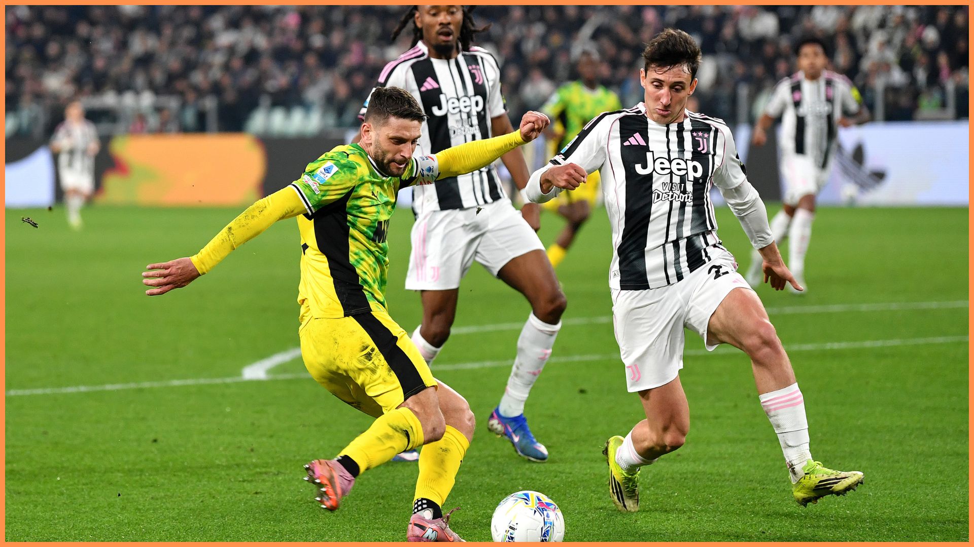 TURIN, ITALY - MARCH 21: Domenico Berardi of US Sassuolo Calcio crosses the ball whilst under pressure from Andrea Cambiaso of Juventus during the Serie A match between Juventus FC and US Sassuolo Calcio at Allianz Stadium on March 21, 2026 in Turin, Italy.